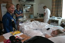 Navy Blue Angel Flight Surgeon Lt. Johannah Valentine visits Aaron Black, 18, at the Children’s Hospital & Medical Center Aug. 28 in Omaha, Neb. The Blue Angels visited the Omaha community with Marine Recruiter Sgt. Karl Krebsbach before they performed at an air show the following weekend.