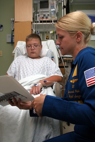 Navy Blue Angel Flight Surgeon Lt. Johannah Valentine teaches Kennedy Feller, 12, about the Blue Angels at the Children’s Hospital & Medical Center Aug. 28 in Omaha, Neb. The Blue Angels visited the Omaha community with Marine Recruiter Sgt. Karl Kebsbach before they performed at an air show the following weekend.