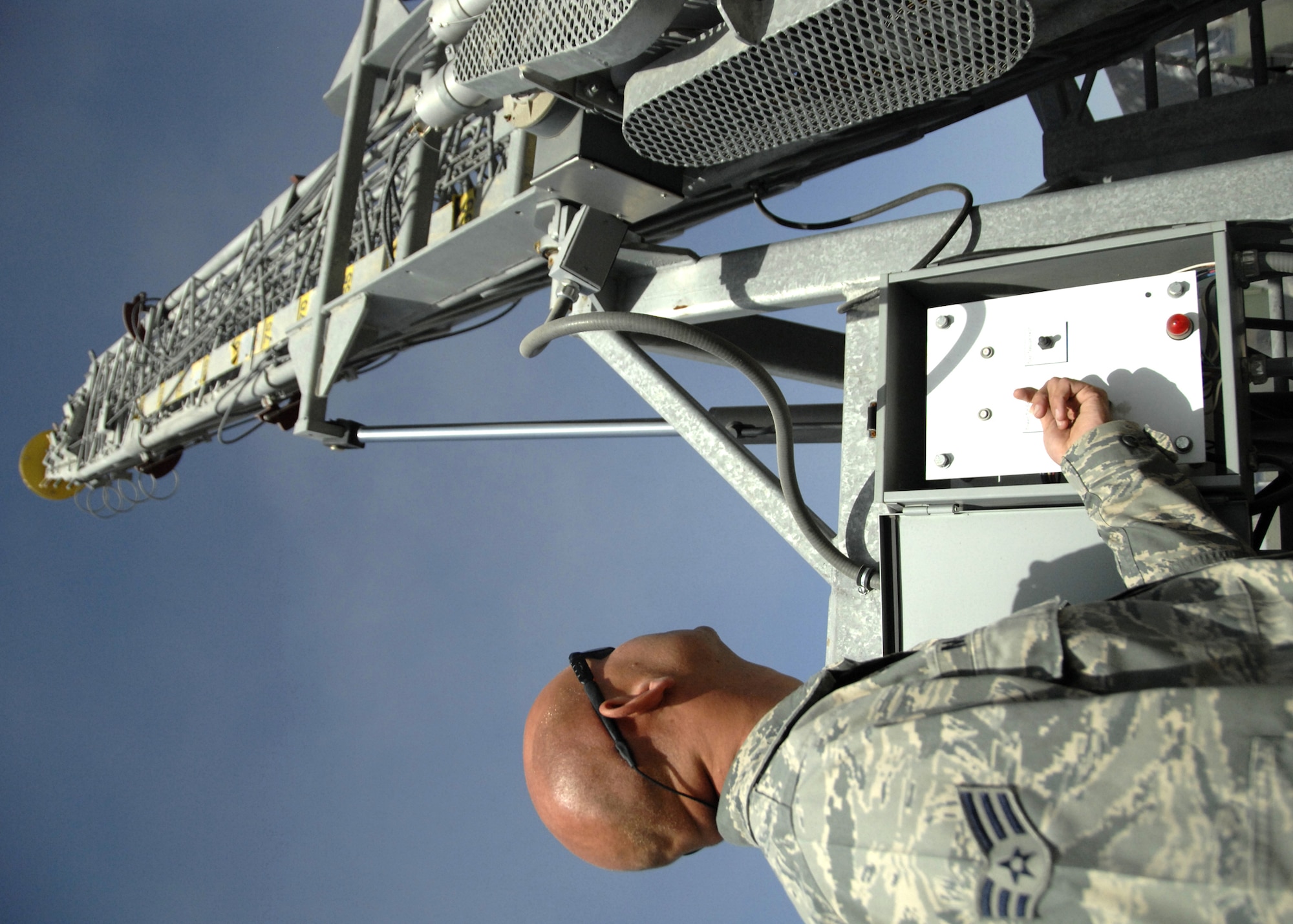 KANDAHAR AIRFIELD, Afghanistan -- Senior Airman Fred Mayhew raises the mast of a new 107-foot antenna at the 73rd Expeditionary Air Control Squadron compound here, Nov. 20. The new antenna will extend the range of radios used by the 73rd EACS for command and control of air assets over Afghanistan. Airman Mayhew is a transmissions systems journeyman with the 73rd EACS from Mountain Home Air Force Base, Idaho. (U.S. Air Force photo/Senior Airman Timothy Taylor)
