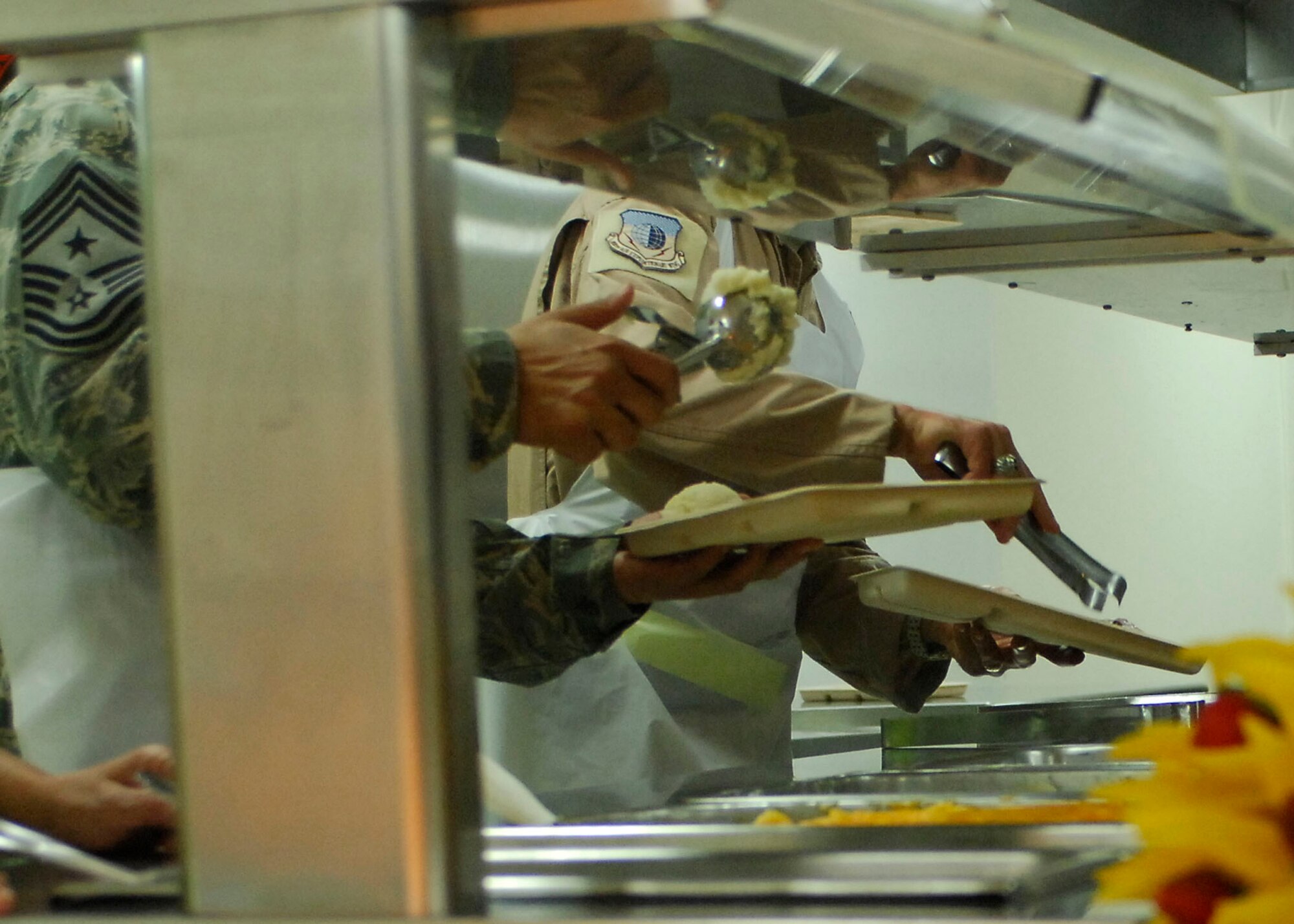 BAGRAM AIRFIELD, Afghanistan -- 455th Air Expeditionary Wing leadership serves Airmen, Soldiers, Sailors and Marines a Thanksgiving Day meal, Nov. 26, 2009.  455th AEW's leadership served meals on Thanksgiving as a way to boost the morale of the servicemen and women.  (U.S. Air Force photo/Senior Airman Felicia Juenke)