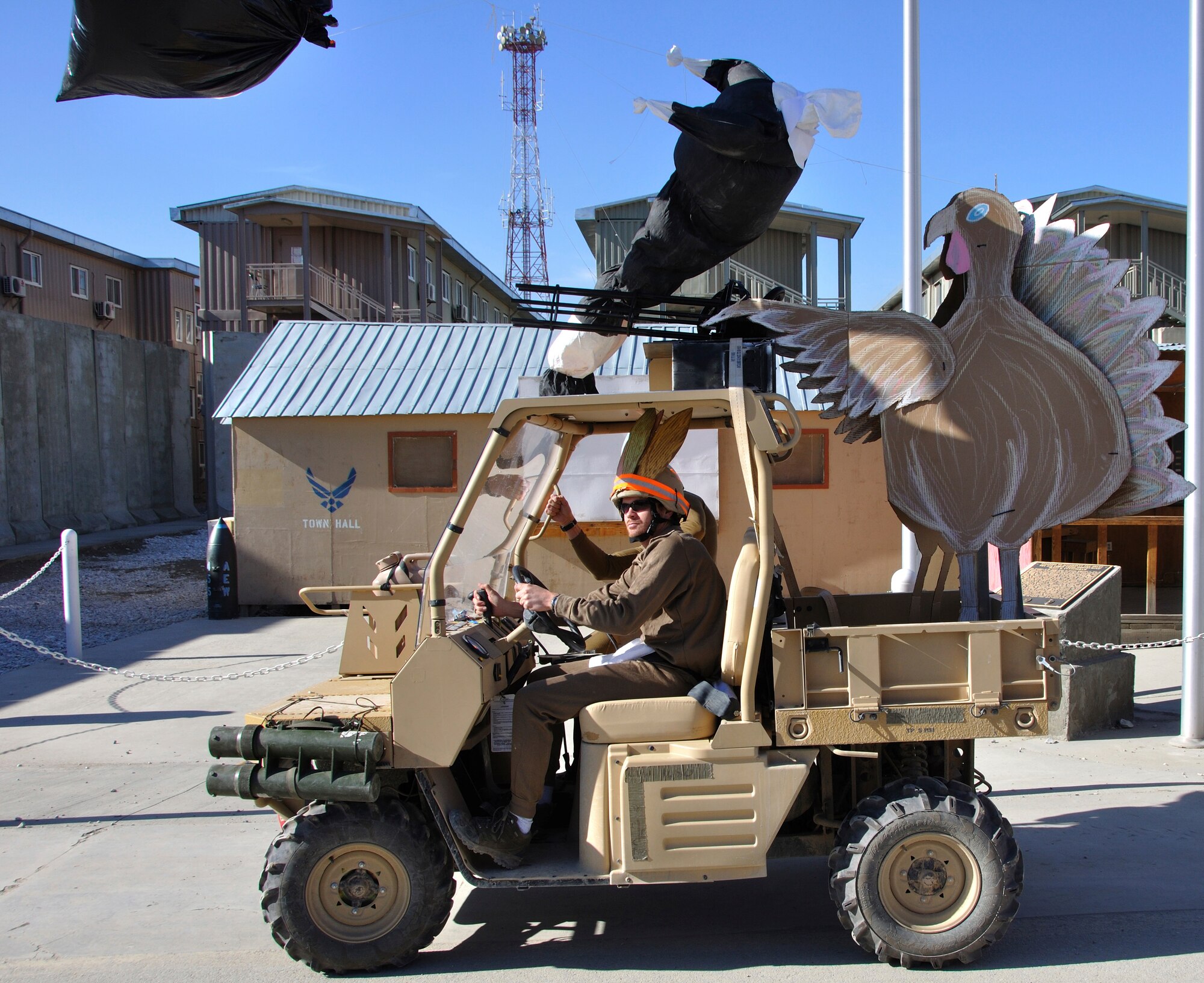 BAGRAM AIRFIELD, Afghanistan -- An all-terrain vehicle decorated as a turkey manning a turret gun drives by a crowd of spectators as part of a Thanksgiving Day parade Nov. 26, 2009. The float was created by a team deployed from the Defense Intelligence Agency and placed third in the judging portion of the event. (U.S. Air Force photo/Tech. Sgt. Joseph Fleming)