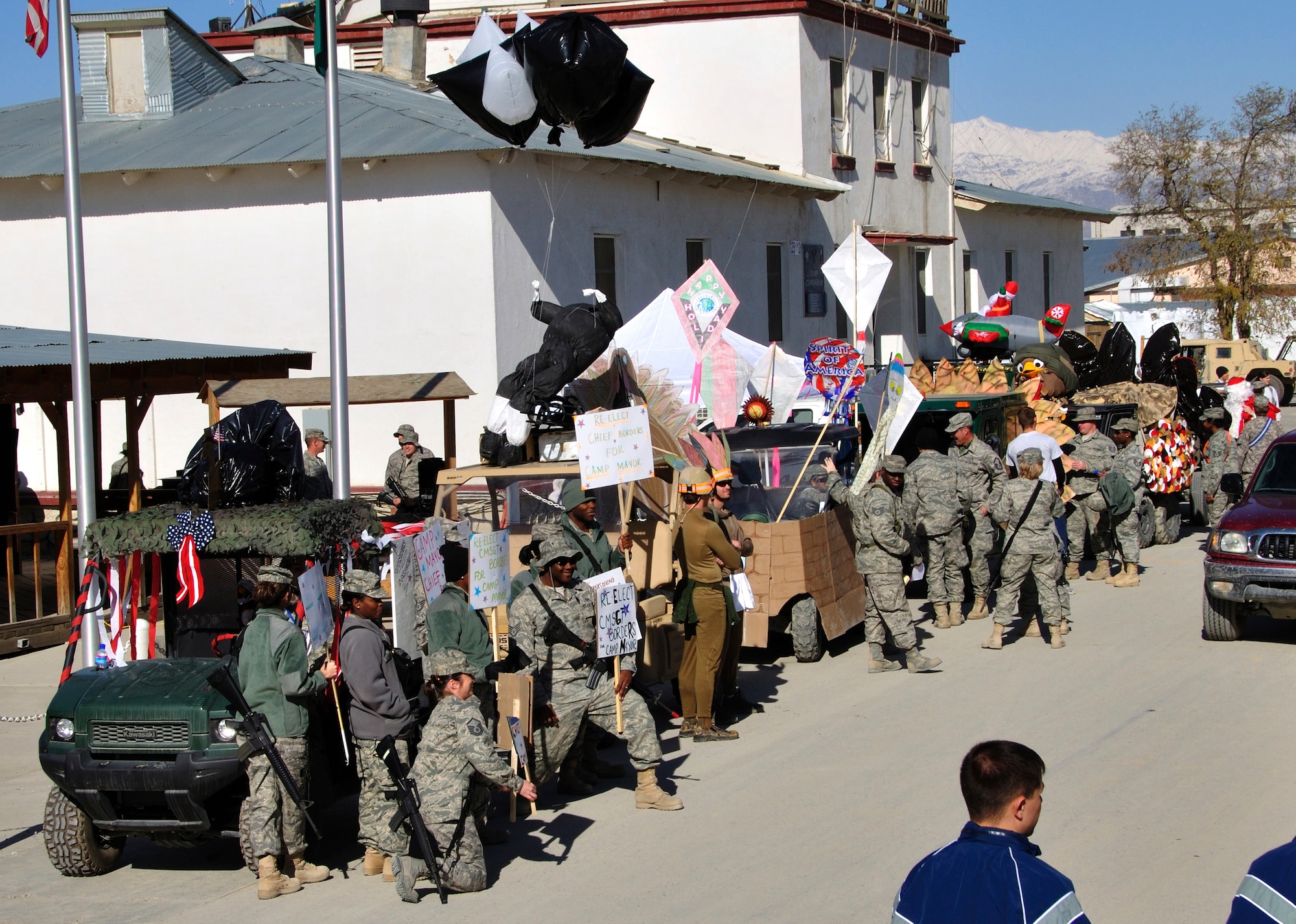 BAGRAM AIRFIELD, Afghanistan -- Thirteen all-terrain vehicles line up as part of a Thanksgiving Day parade Nov. 26, 2009. The parade featured floats created during mission downtime as a recreation of the famous New York City event. The Christmas float, like the parade in New York, featured Santa Claus waving to the crowd, symbolically ushering in the holiday season. (U.S. Air Force photo/Tech. Sgt. Joseph Fleming)