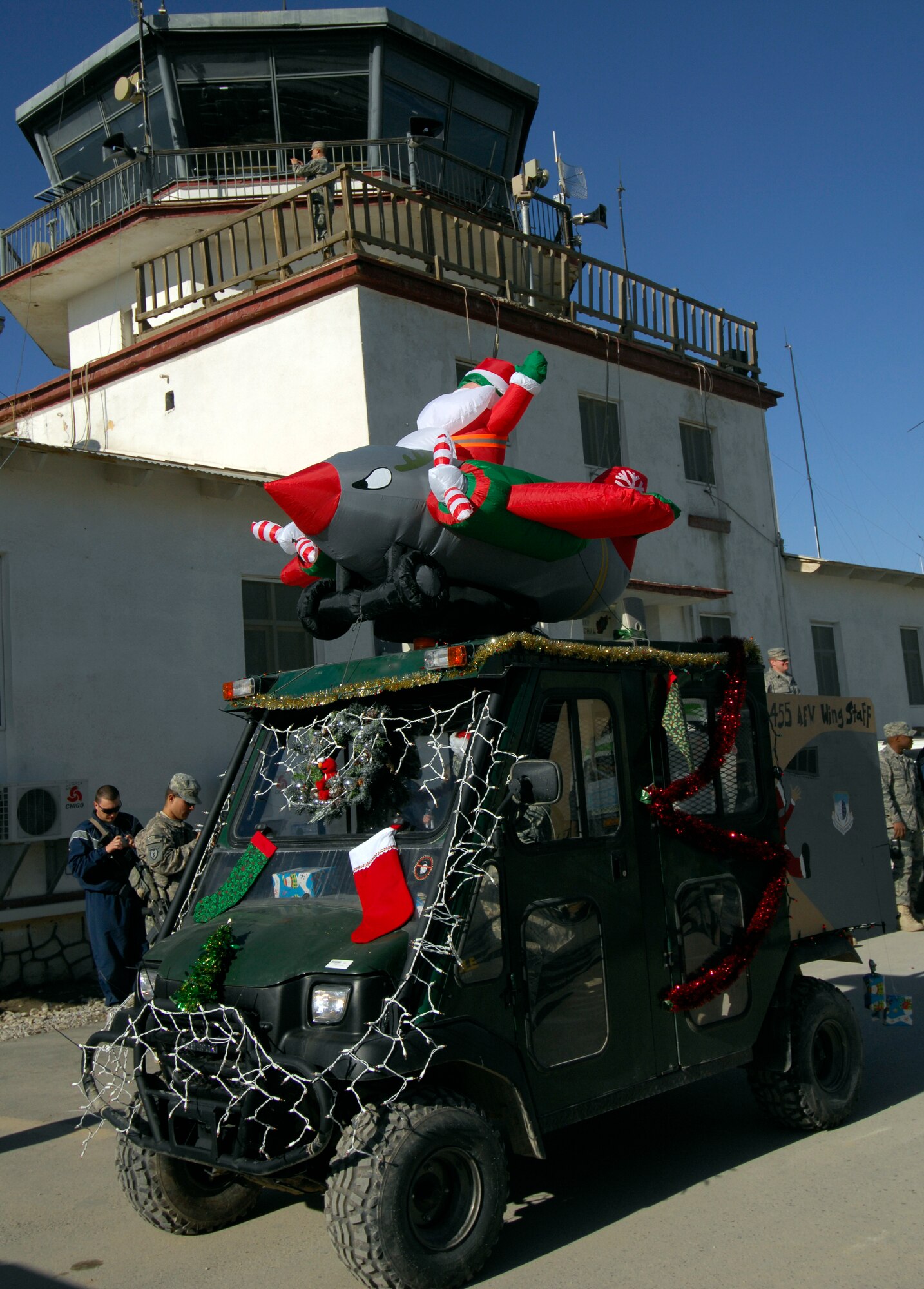 BAGRAM AIRFIELD, Afghanistan -- An all-terrain vehicle decorated for Christmas was the last float as part of a Thanksgiving Day parade Nov. 26, 2009. The parade featured thirteen floats created during mission downtime as a recreation of the famous New York City event. The Christmas float, like the parade in New York, featured Santa Claus waving to the crowd, symbolically ushering in the holiday season. The float was created by the 455th Air Expeditionary Wing staff agencies. (U.S. Air Force photo/Staff Sgt. J.G. Buzanowski)