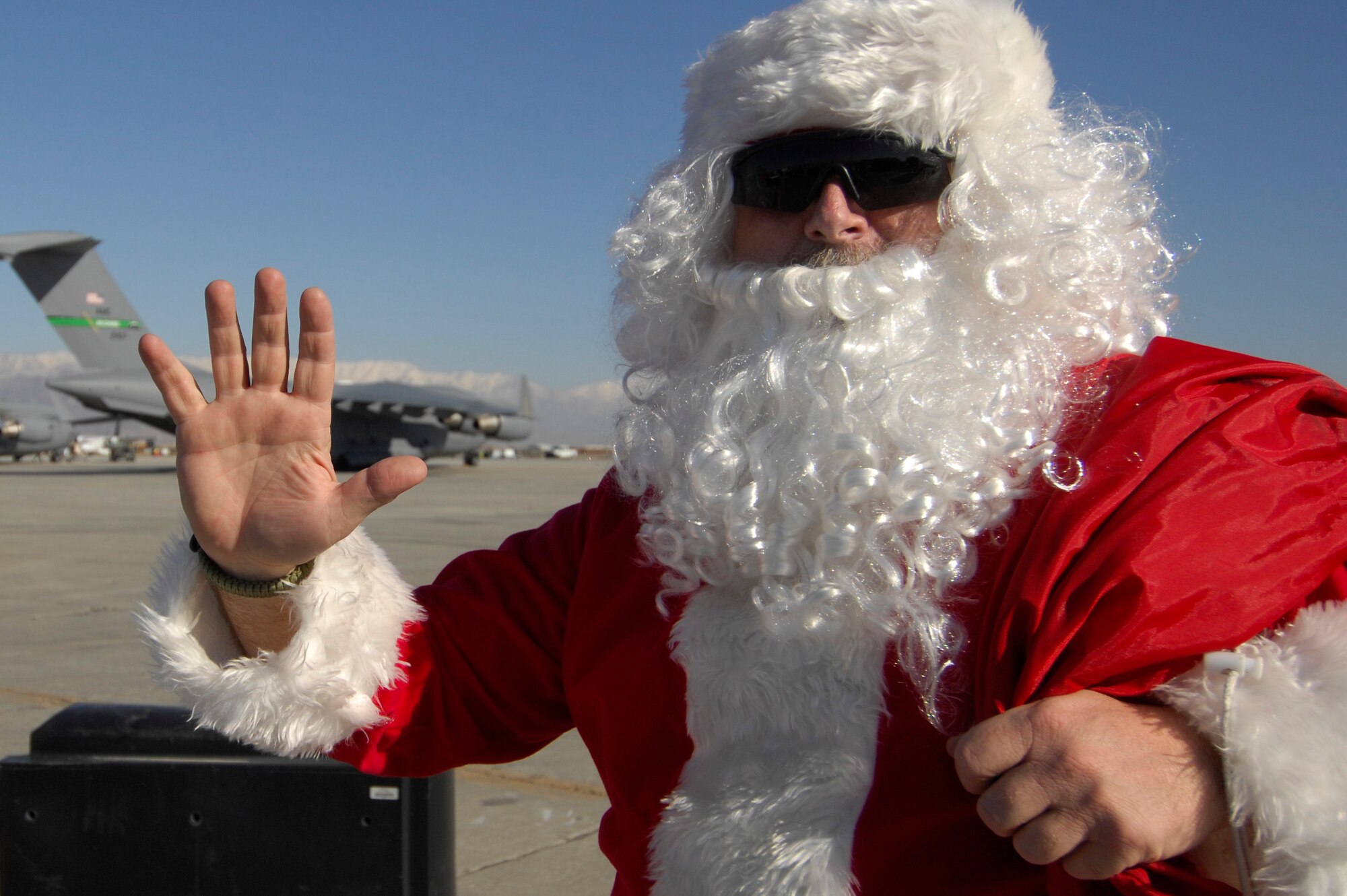 BAGRAM AIRFIELD, Afghanistan -- Santa Claus stops for a photo on the flightline during a Thanksgiving Day parade Nov. 26, 2009. Thirteen floats took part in the event, recreating the famous New York City parade. As with the New York parade, Santa Claus was at the end, symbolically ushering in the holiday season. (U.S. Air Force photo/Staff Sgt. J.G. Buzanowski)