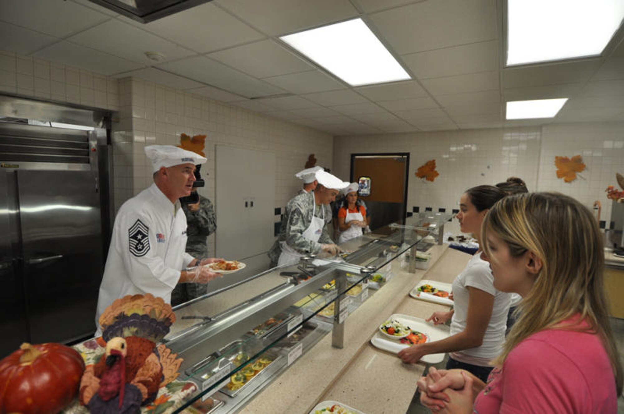 Chief Master Sgt. Brooke McLean, Pacific Air Forces command chief, serves dinner to several guests during Thanksgiving dinner Nov. 26 at the Hale Aina Dining Facility at Hickam Air Force Base, Hawaii. Senior leadership from PACAF joined leaders from 13th Air Force and the 15th Airlift Wing to serve dinner to Hickam Airmen, dependents, family members and retirees. Several members of the Air Force Civilian Advisory Council also volunteered for the event. (U.S. Air Force photo/Staff Sgt. LuCelia Ball)