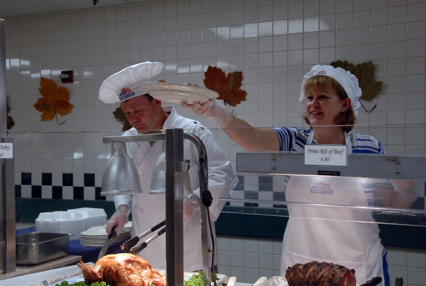 Maj. Gen. Douglas Owens, Pacific Air Forces vice commander, carves turkey for a guest during Thanksgiving dinner Nov. 26 at the Hale Aina Dining Facility at Hickam Air Force Base, Hawaii. Senior leadership from PACAF joined leaders from 13th Air Force and the 15th Airlift Wing to serve dinner to Hickam Airmen, dependents, family members and retirees. Several members of the Air Force Civilian Advisory Council also volunteered for the event. (U.S. Air Force photo/Staff Sgt. LuCelia Ball)