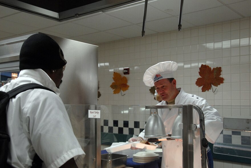 Maj. Gen. Douglas Owens, Pacific Air Forces vice commander, carves turkey alongside Mrs. Teresa Owens, during Thanksgiving dinner Nov. 26 at the Hale Aina Dining Facility at Hickam Air Force Base, Hawaii. Senior leadership from PACAF joined leaders from 13th Air Force and the 15th Airlift Wing to serve dinner to Hickam Airmen, dependents, family members and retirees. Several members of the Air Force Civilian Advisory Council also volunteered for the event. (U.S. Air Force photo/Staff Sgt. LuCelia Ball)