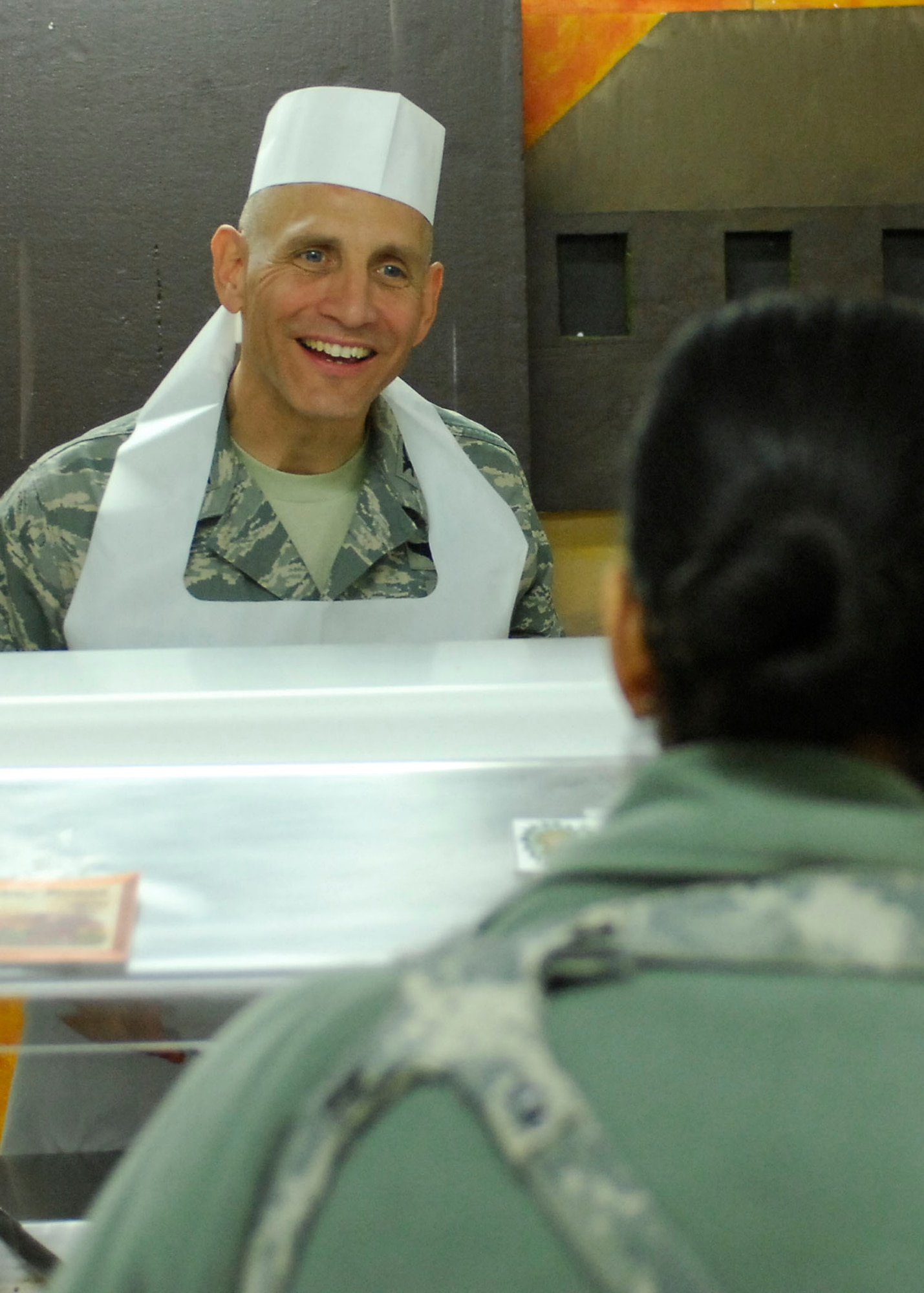 BAGRAM AIRFIELD, Afghanistan -- Colonel James Beissner, 455th Air Expeditionary Wing vice commander, serves an Airman food during a Thanksgiving celebration, Nov. 26, 2009.  Air Force and Army leadership served meals on Thanksgiving as a way to boost the morale of the servicemen and women.  Col. Beissner is deployed from Langley AFB, Va.  (U.S. Air Force photo/Senior Airman Felicia Juenke)