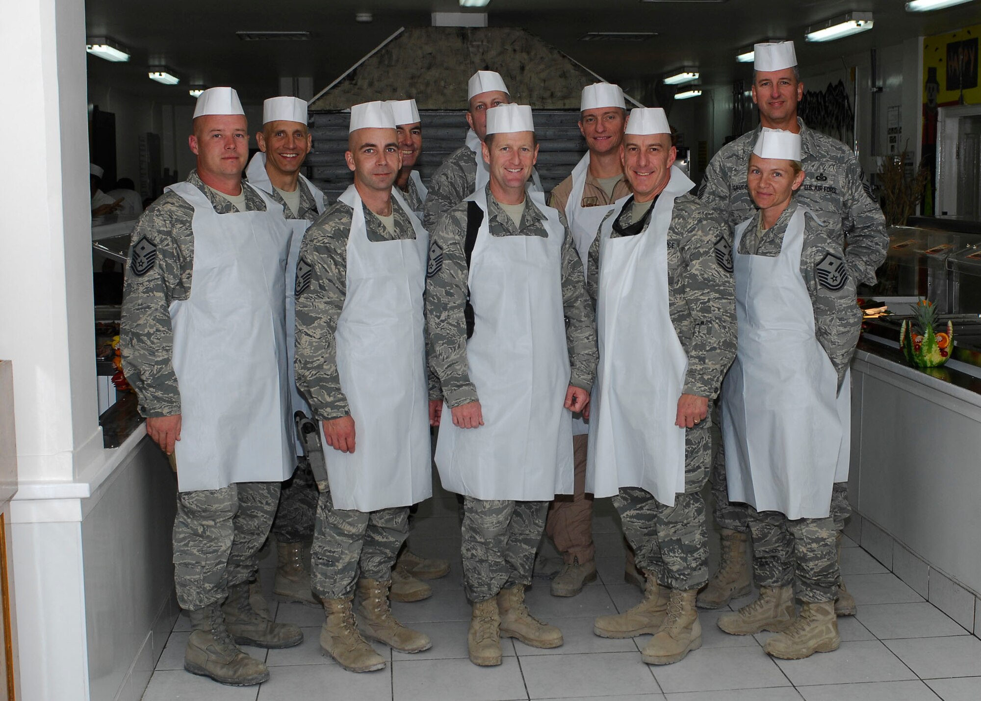 BAGRAM AIRFIELD, Afghanistan -- The vice wing commander, group commanders and first sergeants, of the 455th Air Expeditionary Wing, take a group photo just before the dining facility opens, Nov. 26, 2009.  Air Force and Army leadership served meals on Thanksgiving as a way to boost the morale of the servicemen and women.  (U.S. Air Force photo/Senior Airman Felicia Juenke)