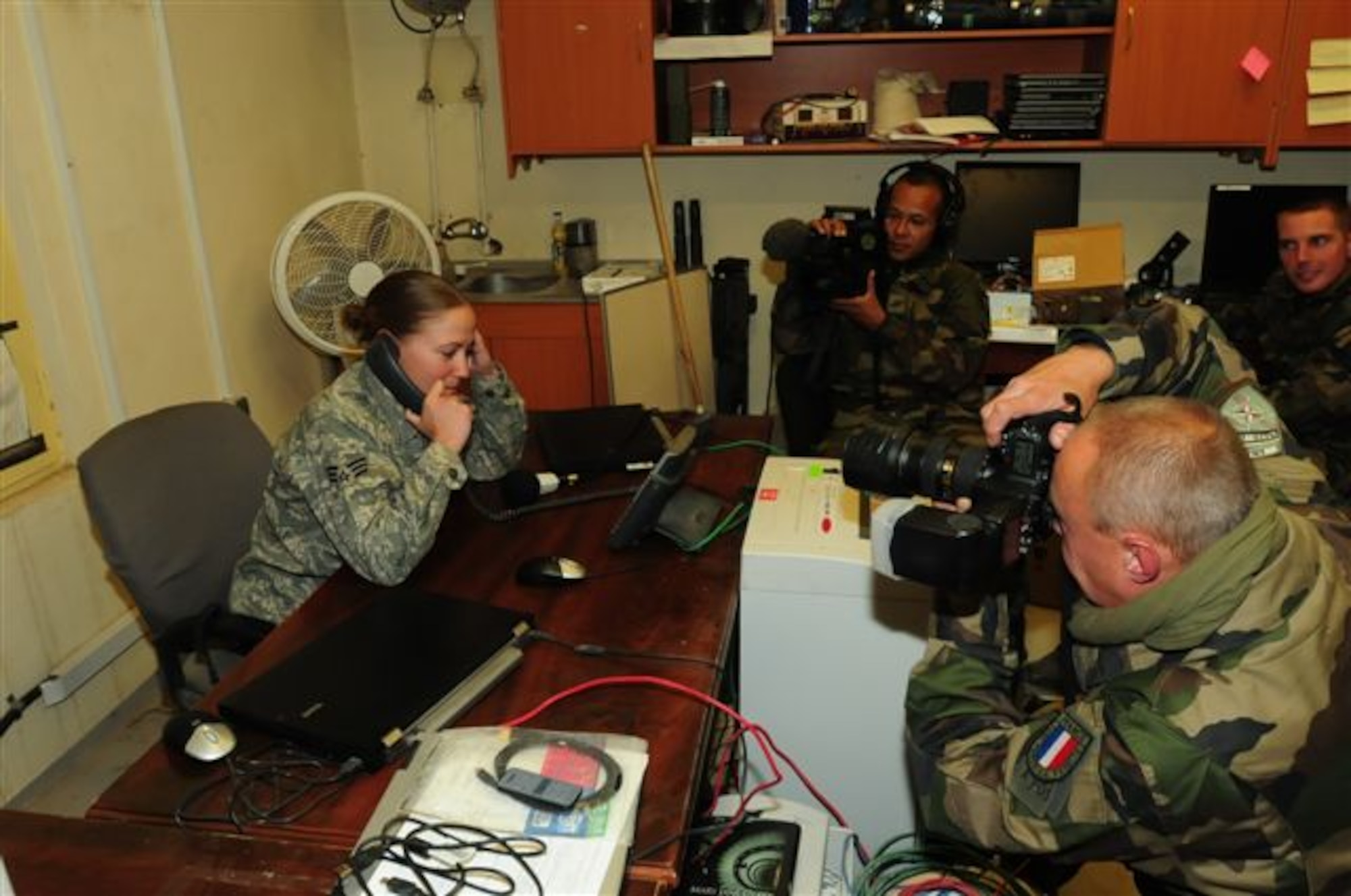 FORWARD OPERATING BASE MORALES-FRAZIER, Afghanistan - Senior
Airman Ashley Jackson, a medic with Provincial Reconstruction Team Kapisa,
receives Thanksgiving greetings from President Obama as French forces film
the conversation. Jackson is originally from Lakeville, Minn., and is deployed to Afghanistan from Eielson Air Force Base, Alaska. (U.S. Air Force photo/Capt. Darrick Lee)
