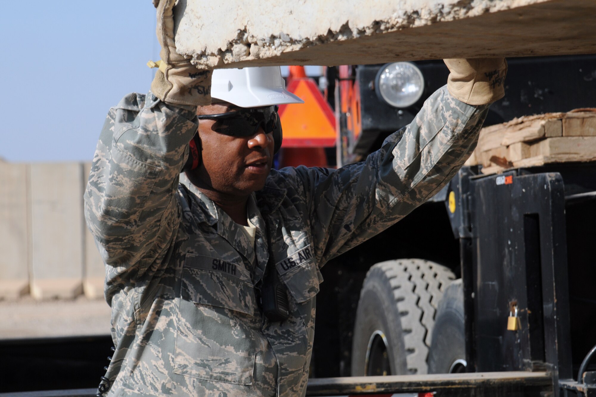 KIRKUK REGIONAL AIR BASE, Iraq –Senior Master Sgt. Jeffrey Smith, 506th Expeditionary Civil Engineer Squadron heavy equipment superintendent, guides a blast wall into position Nov. 23, 2009.  A native of Glen Burnie, Md., Sergeant Smith is deployed from the 512th Civil Engineer Squadron, Dover Air Force Base, Del.  
(U.S. Air Force photo/Staff Sgt. Joshua Breckon)	    
