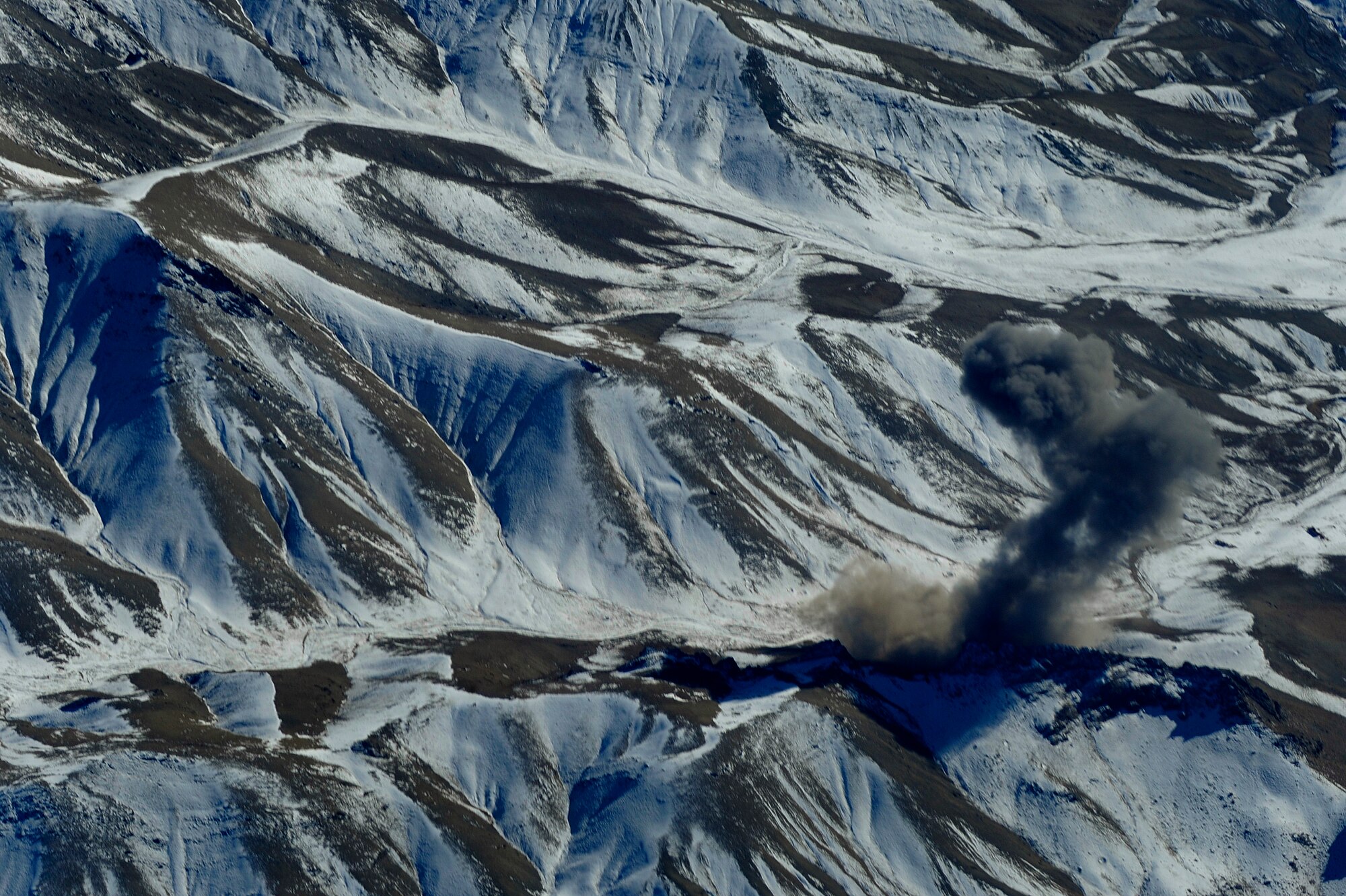 OVER AFGHANISTAN -- Smoke rises from a cave in eastern Afghanistan after it was bombed by U.S. Air Force F-15E Strike Eagles from the 335th Expeditionary Fighter Squadron, Nov. 26, 2009.  The 335th EFS is deployed to Bagram Airfield, Afghanistan, from Seymour Johnson Air Force Base, N.C.  (U.S. Air Force photo/Staff Sgt. Michael B. Keller)

