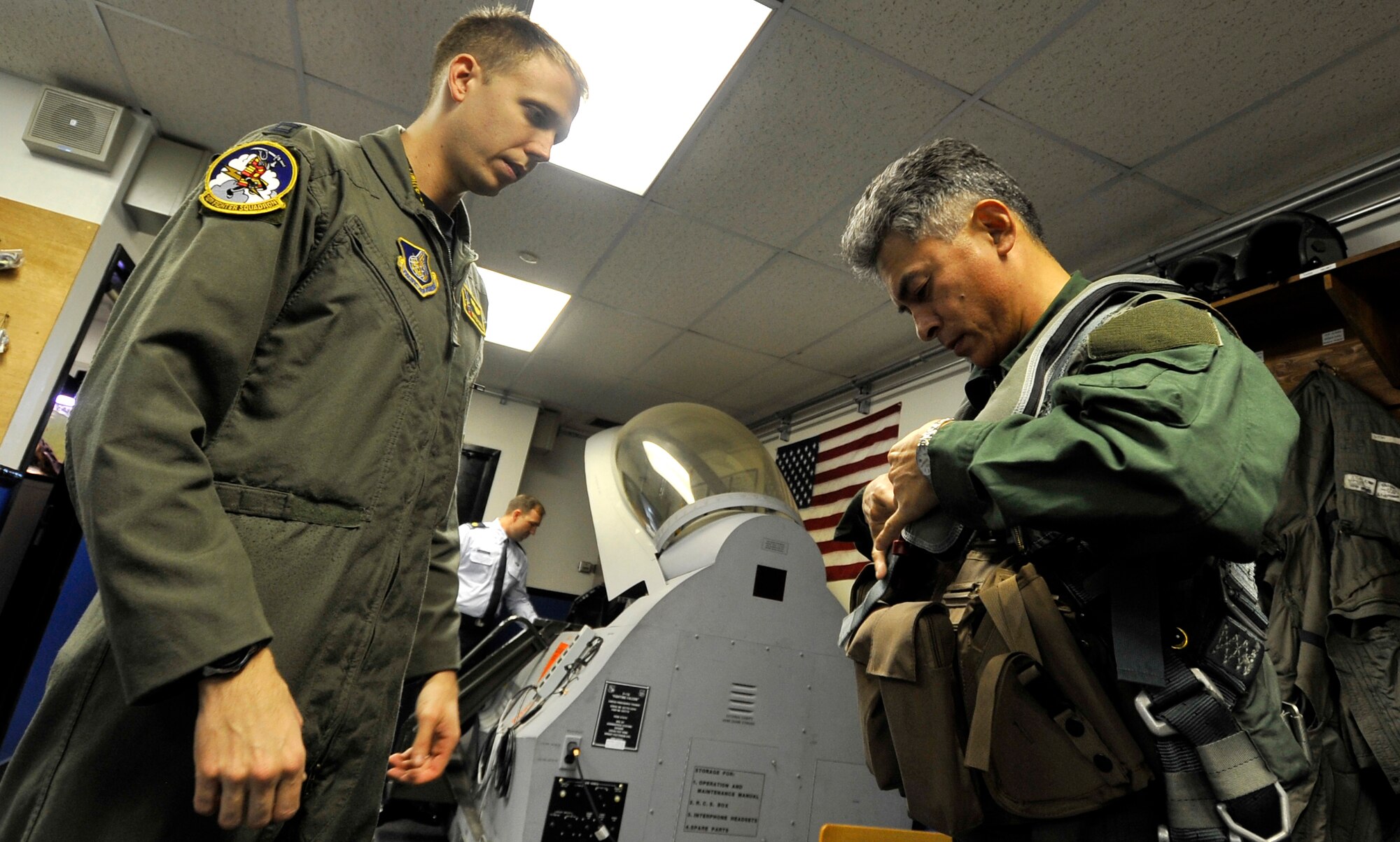 MISAWA AIR BASE, Japan --  Capt. Michael Powell, 13th Fighter Squadron aircrew flight equipment assists Maj. Gen. Hiroaki Maehara, 3rd Air Wing commander with his flight gear before his familiarization flight with Col. RC Craig, 35th Fighter Wing vice commander Nov. 16. Colonel Craig flew General Maehara to show him the differences between American and Japanese aircrafts. (U.S. Air Force photo/Staff Sgt. Chad C. Strohmeyer)