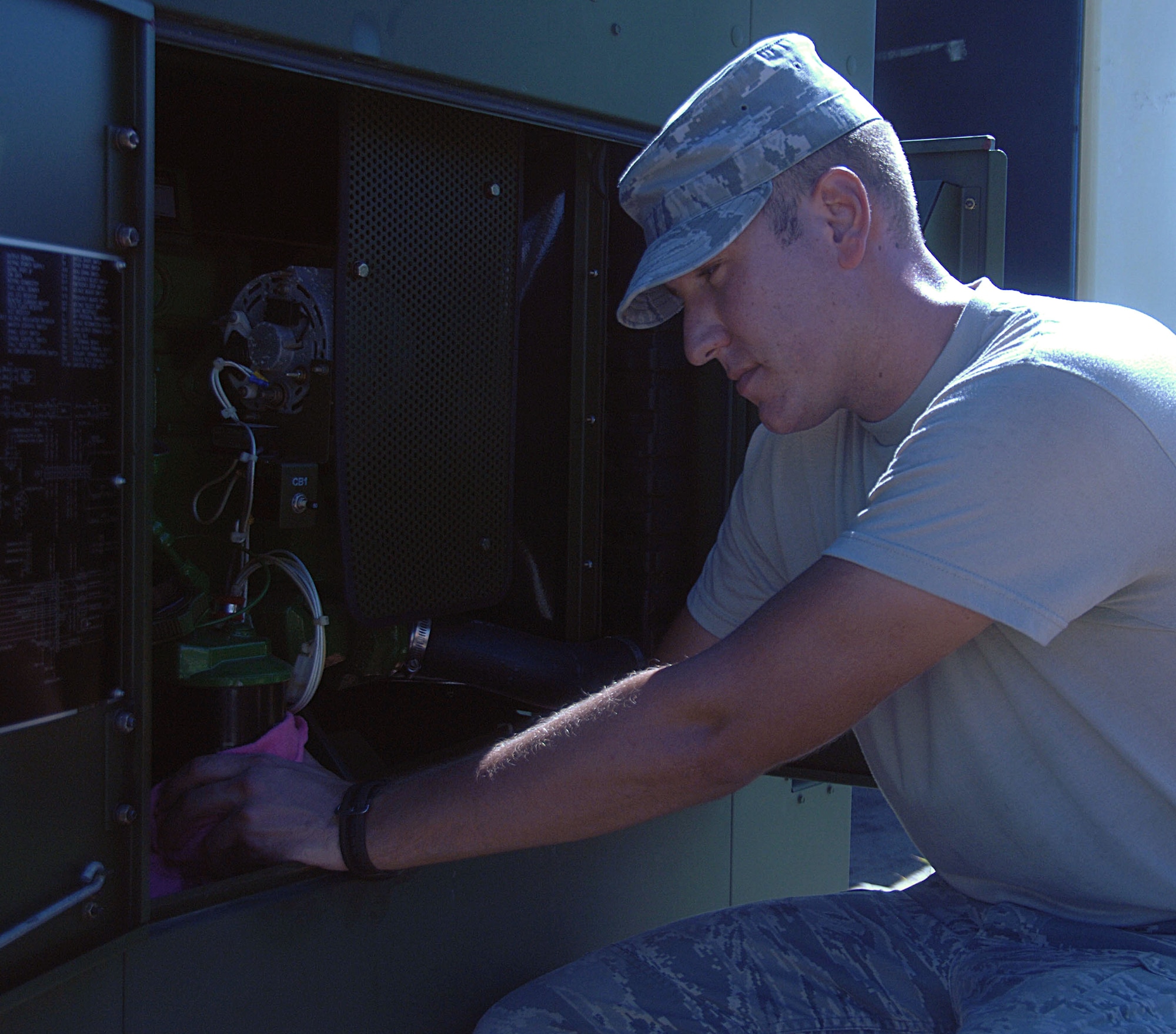 ANDERSEN AIR FORCE BASE, Guam - Airman 1st Class Derrick Bolhofner, 36th Civil Engineer Squadron power production apprentice, changes an oil filter in a mobile generator here Nov. 30. Airman Bolhofner, Andersen AFB's 'Top Performer,' has been in the Air Force for nearly two years. (U.S. Air Force photo by Senior Airman Shane Dunaway)