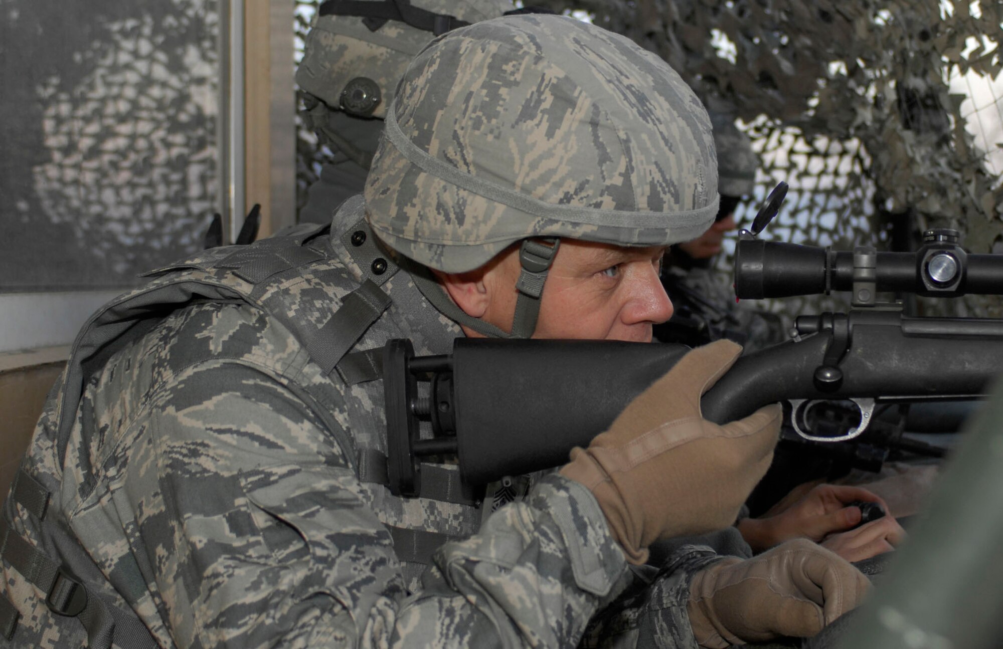 BAGRAM AIRFIELD, Afghanistan -- Chief Master Sgt. of the Air Force James A. Roy looks through the scope of an M-24 sniper weapon at one of Bagram’s observation towers. Chief Roy visited Bagram to talk with Airmen from the 455th Expeditionary Security Forces Squadron to hear what the Airmen had on their minds in a deployed environment. "I wanted to also thank you, your spouses and your family for the sacrifices you and they are making while you are deployed defending our nation," he said.  (U.S. Air Force photo/Tech. Sgt. John Jung)