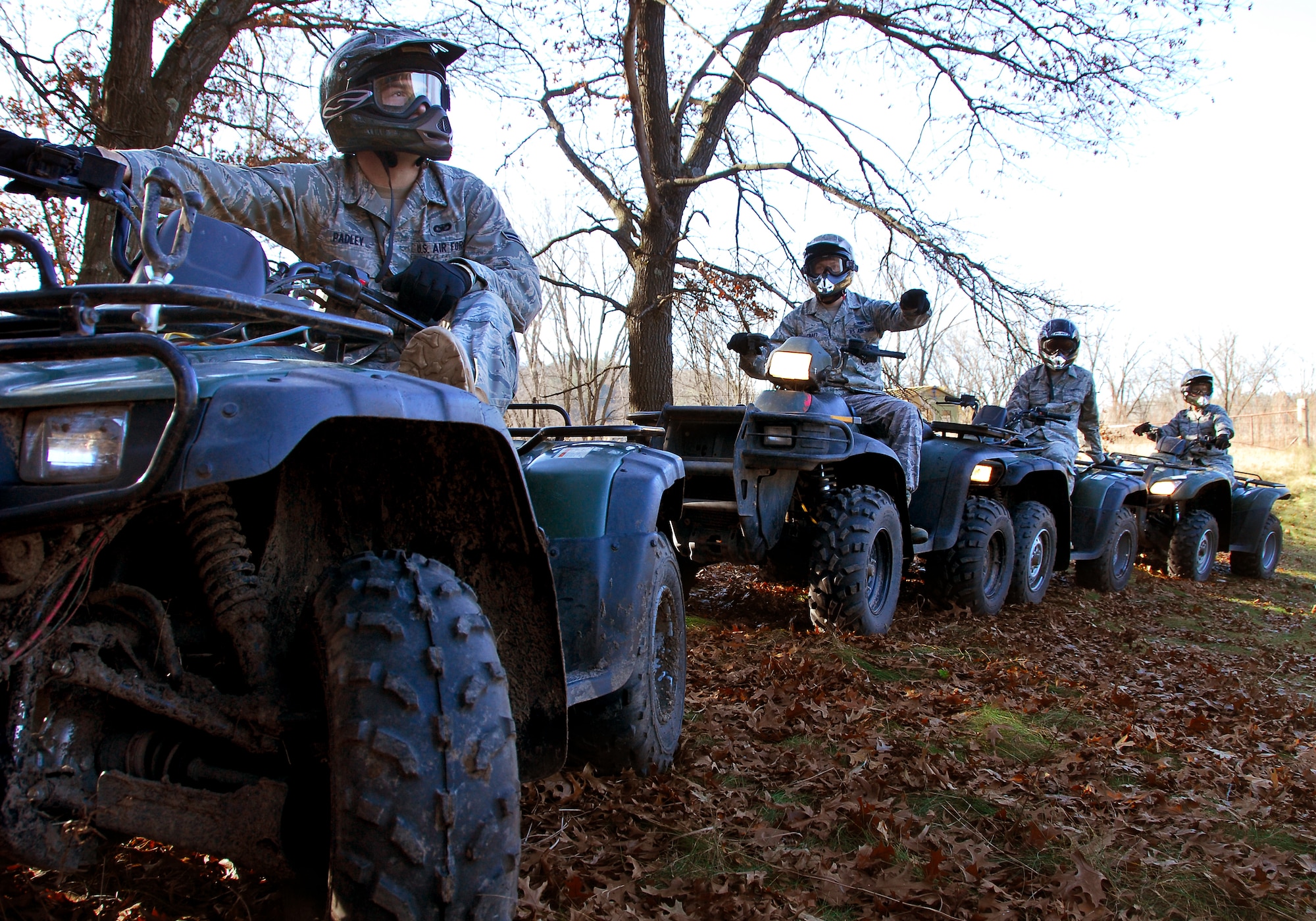 Airmen First Class Justin Padley (left) awaits his turn to navigate a hill with his All Terrain Vehicle during a training course of instruction at Volk Field Combat Readiness Training Center Nov. 1, 2009.  115th SF Airmen attended this training course to learn how to operate an A.T.V in various environments, a requirement for their job. (U.S. Air Force photo by Staff Sgt. Christen Bloomfield)