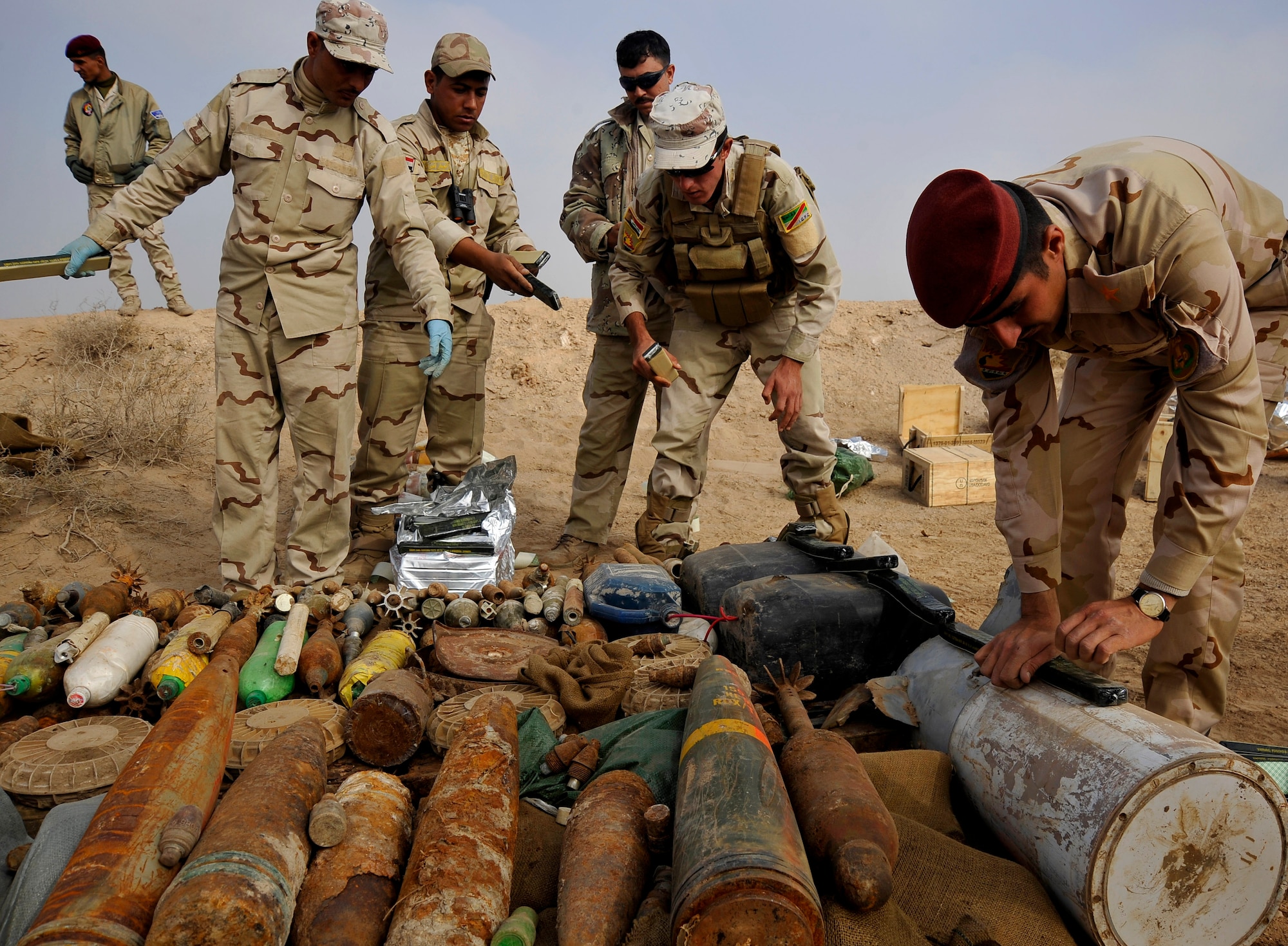 Iraqi Army Soldiers in Mahmudiyah, Iraq, place C-4 explosives on a collection of loose ordnance in  preparation for a control detonation, Nov. 23, 2009. The purpose of the control detonation is to mitigate explosives hazards and limit the enemy's war-fighting capabilities in Iraq. (U.S. Air Force photo/Staff Sgt. Angelita Lawrence)
