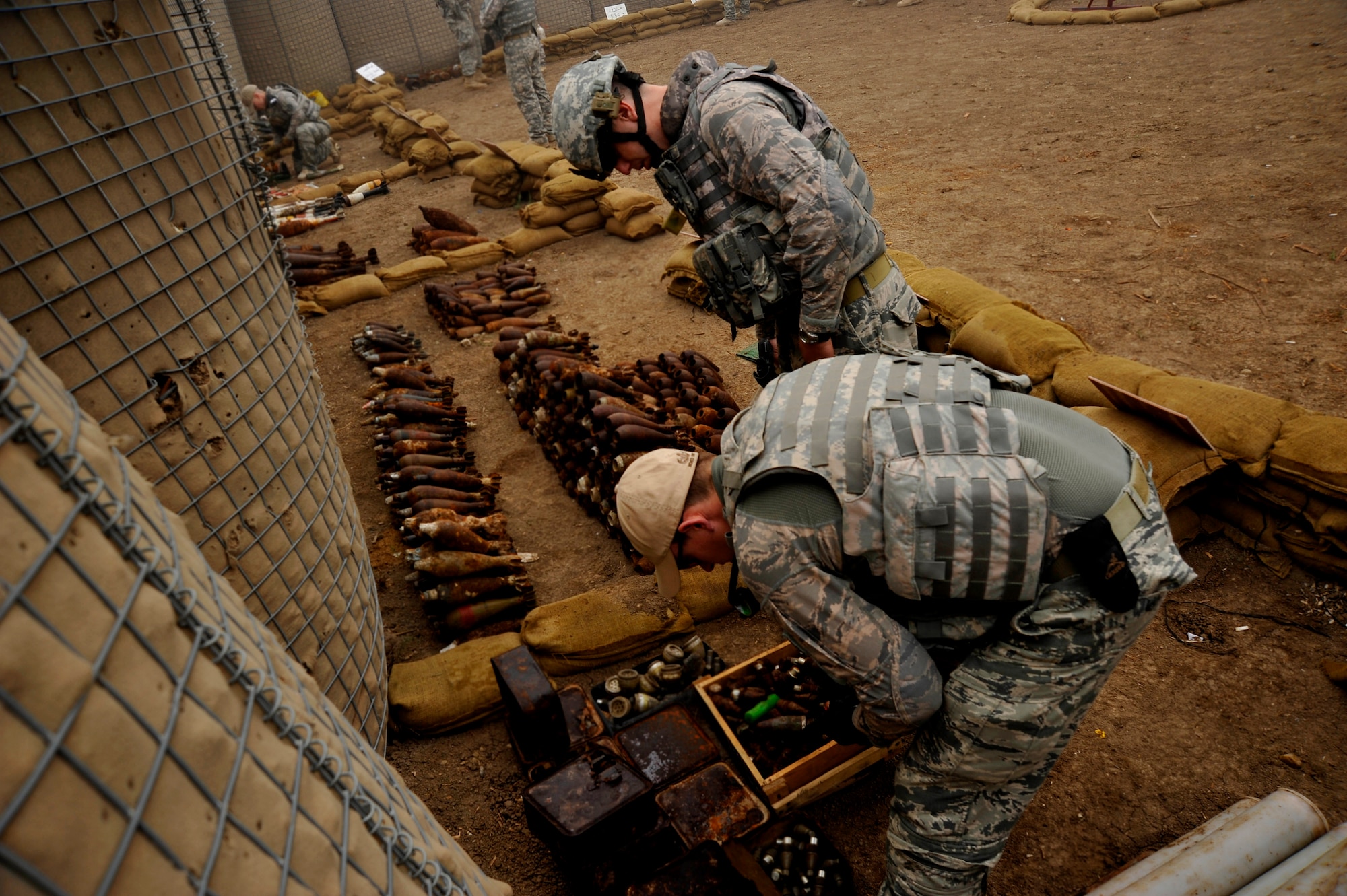 U.S. Air Force Staff Sgts. Cody Flood and Michael Jamison, 447th Expeditionary Civil Engineer Squadron explosive ordinance disposal technicians, deployed to Mahmudiyah, Iraq, collect data on explosives in preparation for a controlled denotation, Nov. 23, 2009.  (U.S. Air Force photo/Staff Sgt. Angelita Lawrence)
