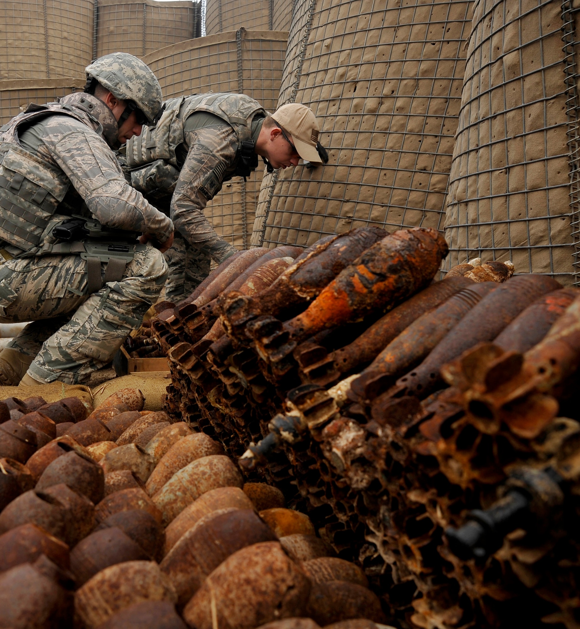 U.S. Air Force Staff Sgts. Cody Flood and Michael Jamison, 447th Expeditionary Civil Engineer Squadron explosive ordinance disposal technicians, deployed to Mahmudiyah, Iraq, collect data on explosives in preparation for a controlled detonation, Nov. 23, 2009. (U.S. Air Force photo/Staff Sgt. Angelita Lawrence)