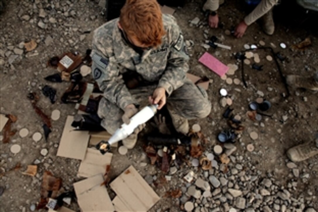 U.S. Army Pfc. Jerrod Lynch removes packaging from ammunition his unit received during a routine aerial re-supply on Combat Outpost Cherkatah, Khowst province, Afghanistan, Nov. 26, 2009. Lynch is deployed with Company D, 3rd Battalion, 509th Infantry Regiment. 