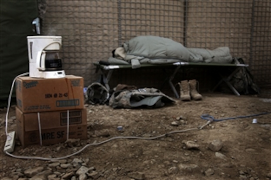 A U.S. Army soldier sleeps while the first pot of coffee of the day brews on Combat Outpost Cherkatah, Khowst province, Afghanistan, Nov. 27, 2009. The soldier is deployed with Company D, 3rd Battalion, 509th Infantry Regiment. 