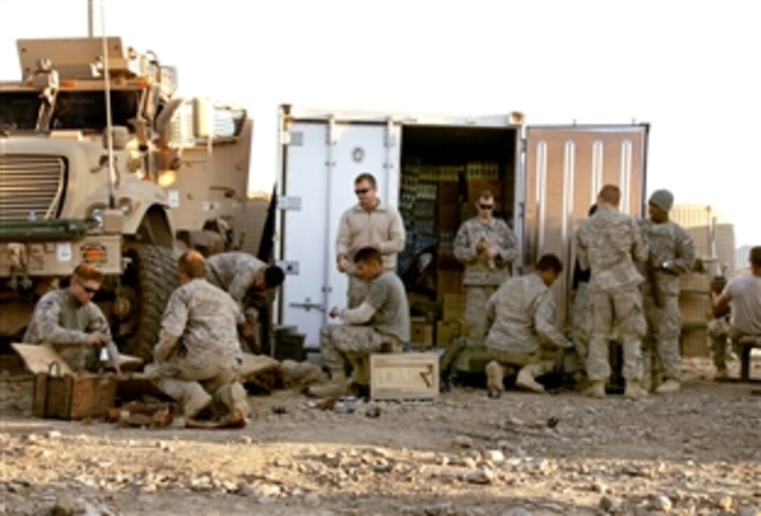 U.S. Army soldiers remove packaging from ammunition they received during a routine aerial re-supply on Combat Outpost Cherkatah, Khowst province, Afghanistan, Nov. 26, 2009. The soldiers are deployed with Company D, 3rd Battalion, 509th Infantry Regiment.