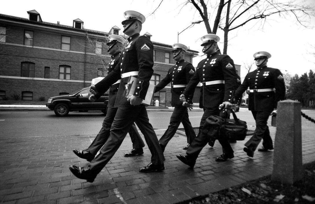 Marine Corps body bearers march from their barracks to the bus to transport them to the day’s funeral Nov. 30, 2009 before preparing for the days funerals. Body bearers carry the remains of fallen Marines to their final resting place in Arlington and surrounding cemeteries in the National Capital Region.