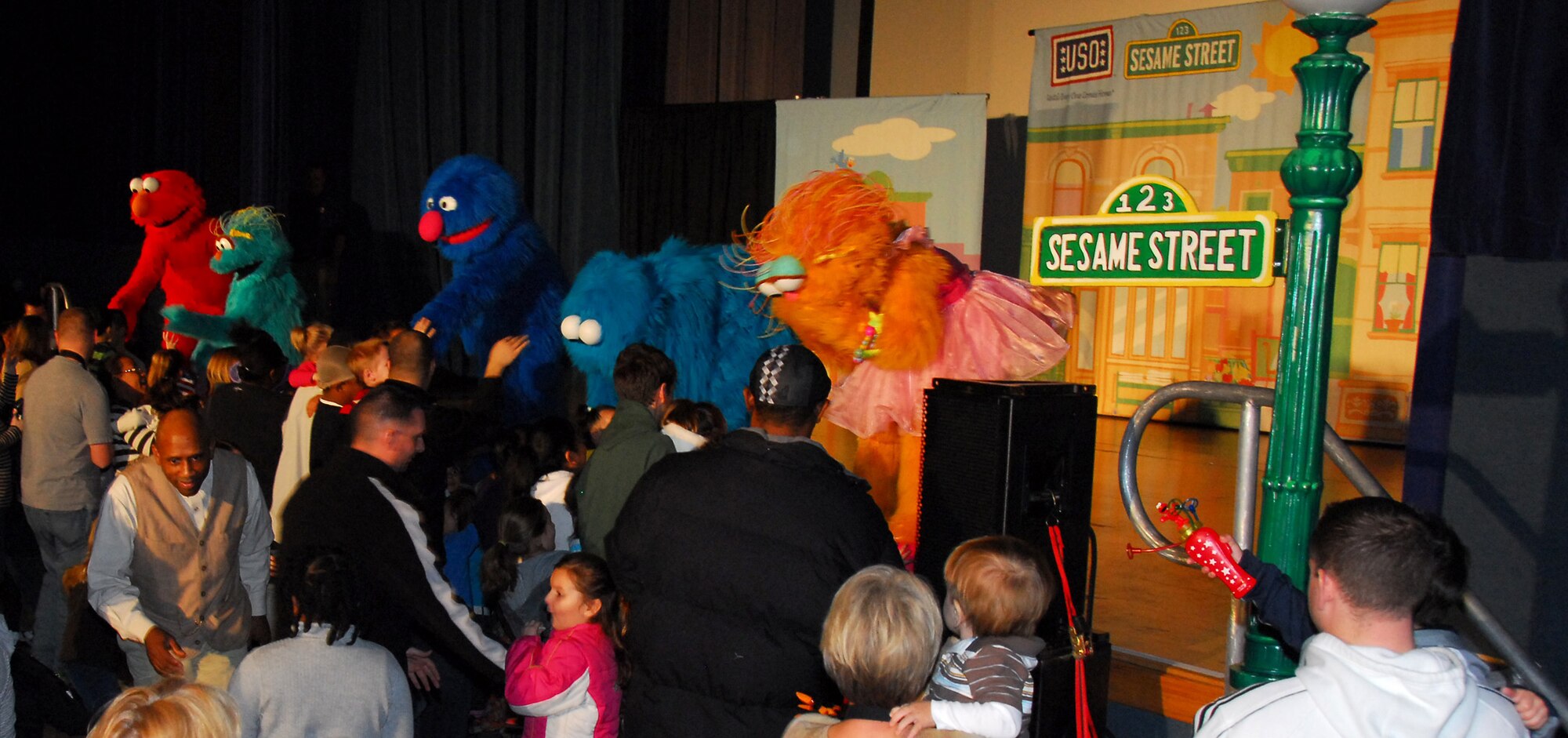 Dozens of children meet Sesame Street characters during a USO sponsored show Nov. 28 at Eielson Air Force Base, Alaska. The free Sesame Street/USO Experience is a live character tour is scheduled to perform a series of high energy shows tailored specifically for military families at 20 military installations worldwide. The tour provides support and offers resources for military families with young children experiencing the effects of deployment. (U.S. Air Force photo/Tech. Sgt. Shad Eidson)