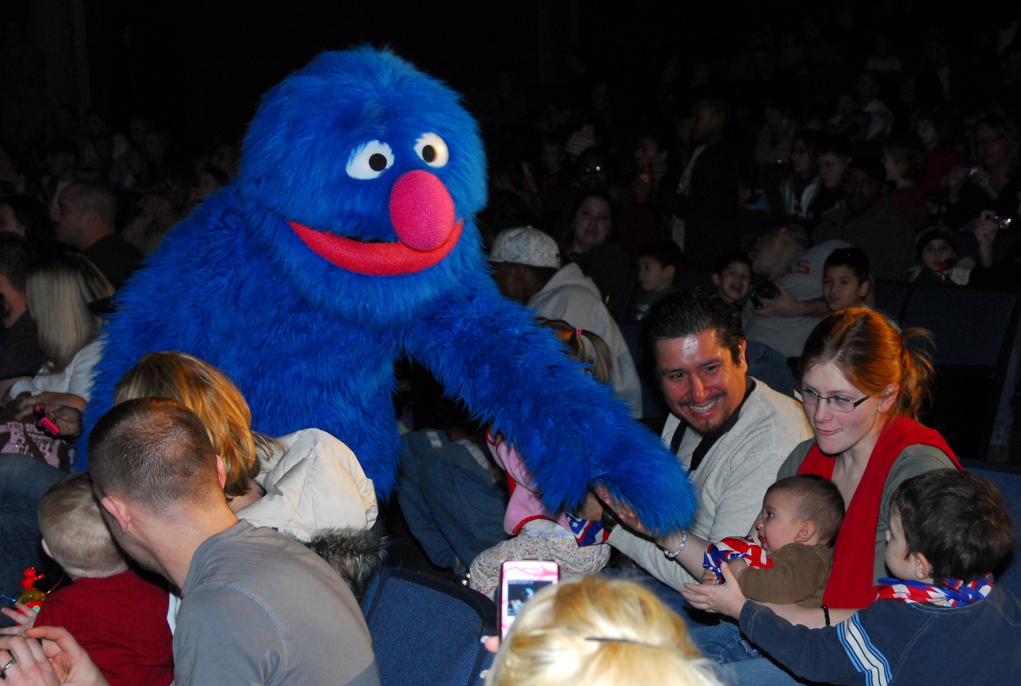 Sesame Street's Grover goes into the crowd to meet children of military families during a USO sponsored show Nov. 28 at Eielson Air Force Base, Alaska. The live character tour is scheduled to perform a series of high energy shows tailored specifically for military families at 20 military installations worldwide. The tour provides support and offers resources for military families with young children experiencing the effects of deployment. (U.S. Air Force photo/Tech. Sgt. Shad Eidson)