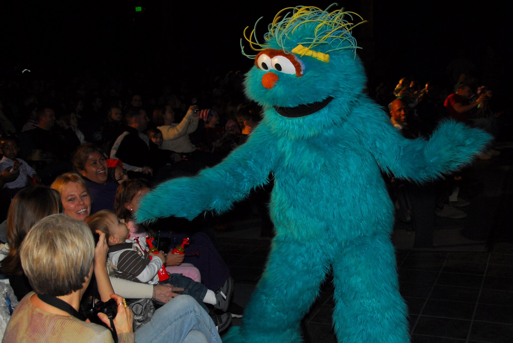 Sesame Street's Rosita interacts with children of military families during a USO sponsored show Nov. 28 at Eielson Air Force Base, Alaska. The free Sesame Street/USO Experience is a live character tour and part of Sesame Street's talk, listen, connect initiative for military families. (U.S. Air Force photo/Tech. Sgt. Shad Eidson)