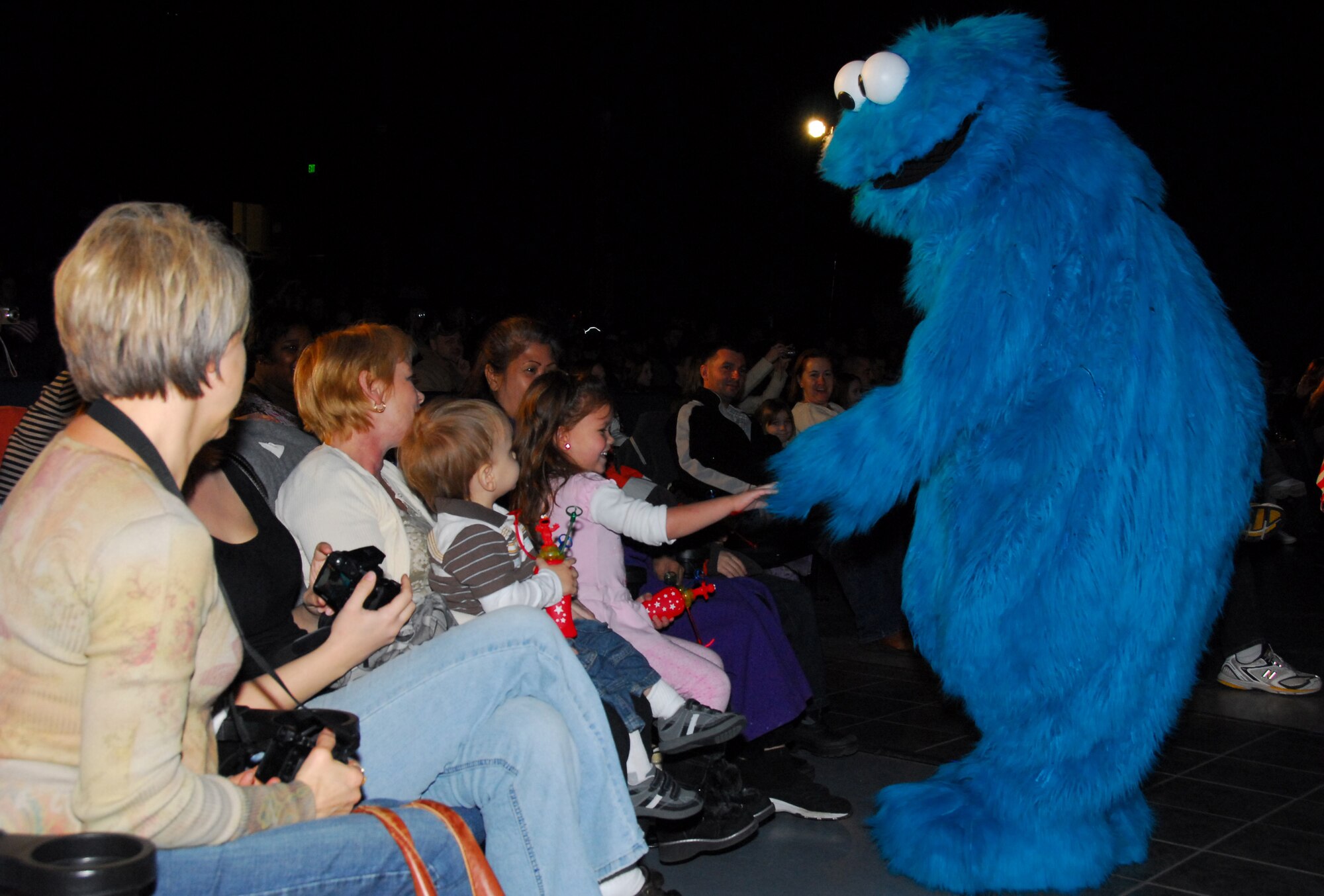 Sesame Street's Cookie Monster greets children of military families during a USO sponsored show Nov. 28 at Eielson Air Force Base, Alaska. The free Sesame Street/USO Experience is a live character tour and part of Sesame Street's talk, listen, connect initiative for military families. (U.S. Air Force photo/Tech. Sgt. Shad Eidson)