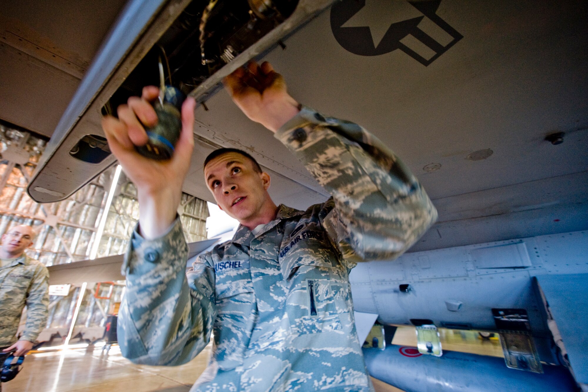 MISAWA AIR BASE, Japan -- Senior Airman Jesse Leuschel, 14th Aircraft Maintenance Unit load-crew member, prepares an F-16 Fighting Falcon for ordnance during a weapons-load crew competition Nov. 25 at Hangar 911. The competition placed three of the base's best load crews against each other to crown the weapons-load crew of the year. (U.S. Air Force photo/Senior Airman Jamal D. Sutter)