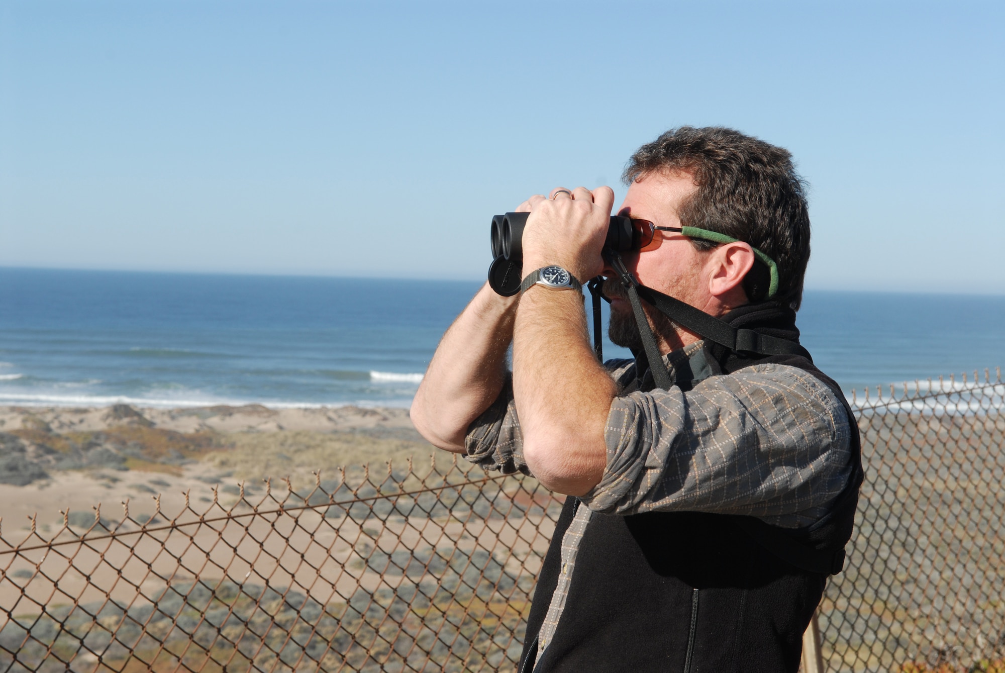 VANDENBERG AIR FORCE BASE, Calif. – Using his binoculars, Darryl York, a 30th Civil Engineer Squadron environmental flight wildlife biologist, looks out over the work his team has done to preserve an endangered species, the California Least Tern Management Team. Mr. York was a part of the Purisima Point Least Tern Management Team that earned the 2009 Coastal America Partnership Award for their ecosystem-based management approach in protecting the California Least Tern off of Vandenberg’s coast. (U.S. Air Force photo/Airman 1st Class Angelina Drake)