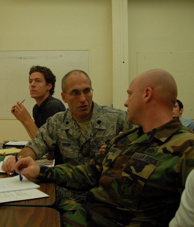 Lt. Col. Mark Green and Maj. Jacob Salmond discuss a potential master plan concept conceived by Kansas State University students as part of a unique partnership between K-State and the 190th ARW.
(photo by Tech. Sgt. Angela Brees)