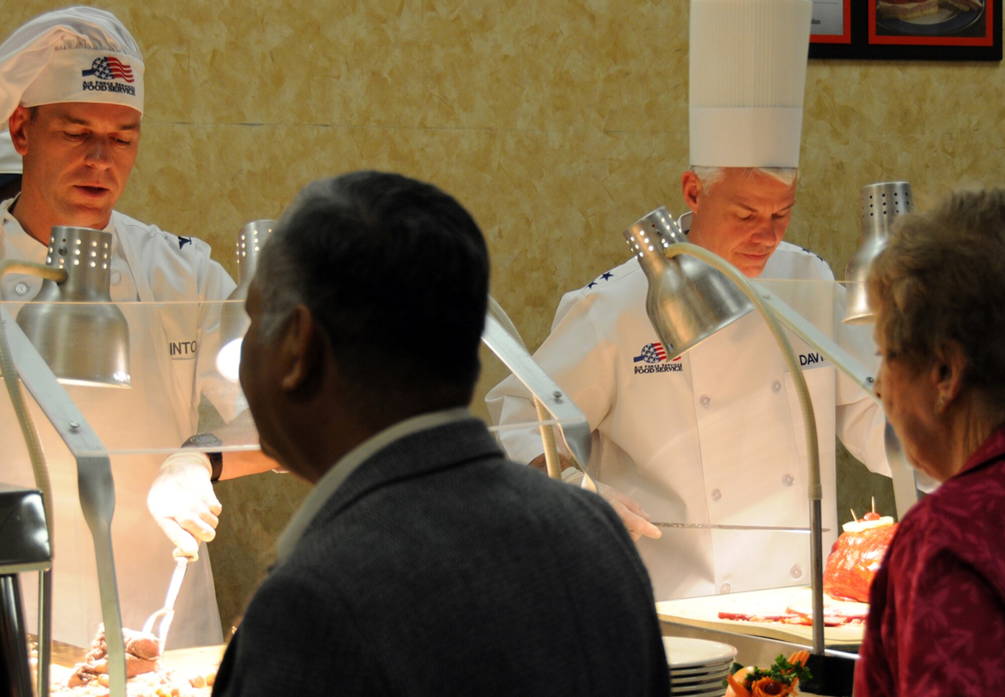EGLIN AIR FORCE BASE, Fla. -- Col. Bruce McClintock, 96th Air Base Wing commander was joined by Maj. Gen. Charles Davis, Air Armament Center commander and program executive officer for weapons, and other senior base leadership serving meals at the Eglin Breeze Dining Facility for Thanksgiving, Nov. 26. Turkey, roast beef and all the trimmings were available to Eglin Warriors, dependants, visiting family members and retirees. The facility prepared food in anticipation for about 550 guests. (U.S. Air Force photo/Airman Anthony Jennings)