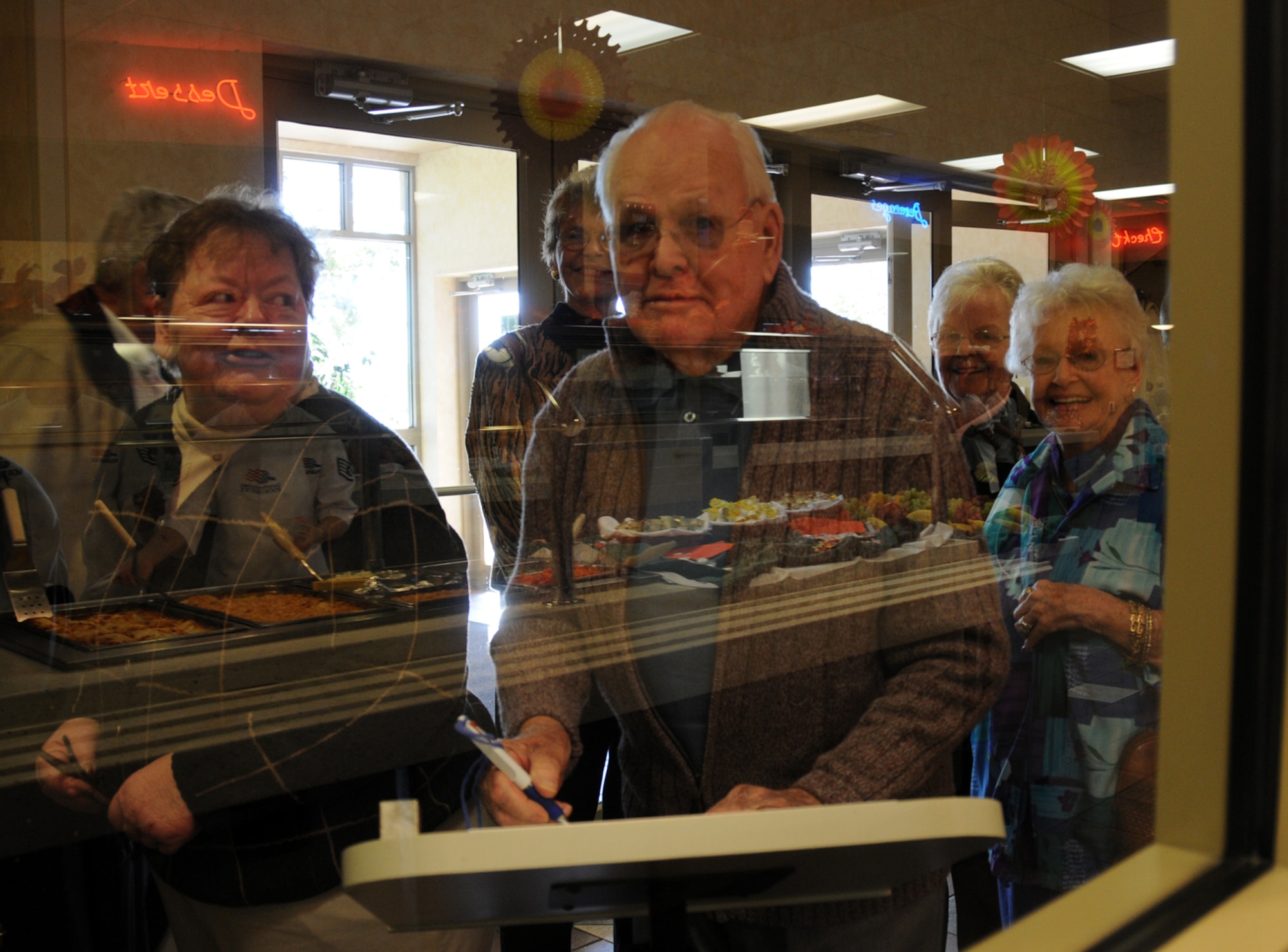 EGLIN AIR FORCE BASE, Fla. –  Customers eagerly wait for the Thanksgiving meal at the Eglin Breeze Dining Facility, Nov. 26. Turkey, roast beef and all the trimmings were available to Eglin Warriors, dependants, visiting family members and retirees for Thanksgiving. Col. Bruce McClintock, 96th Air Base Wing commander was joined by Maj. Gen. Charles Davis, Air Armament Center commander and program executive officer for weapons, and other senior base leadership serving food to customers. The facility prepared food in anticipation for about 550 guests. (U.S. Air Force photo/Airman Anthony Jennings)
