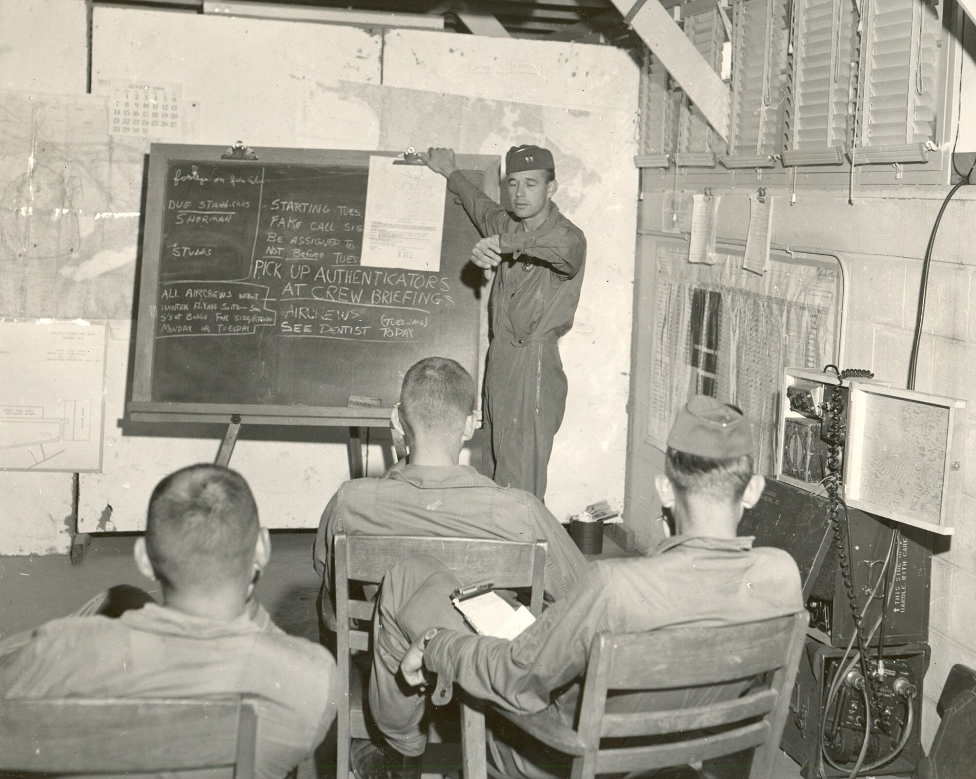 Capt. Gene Crackle briefs aircrew members prior to their missions, possibly at summer camp at Alpena, Mich., in 1959.