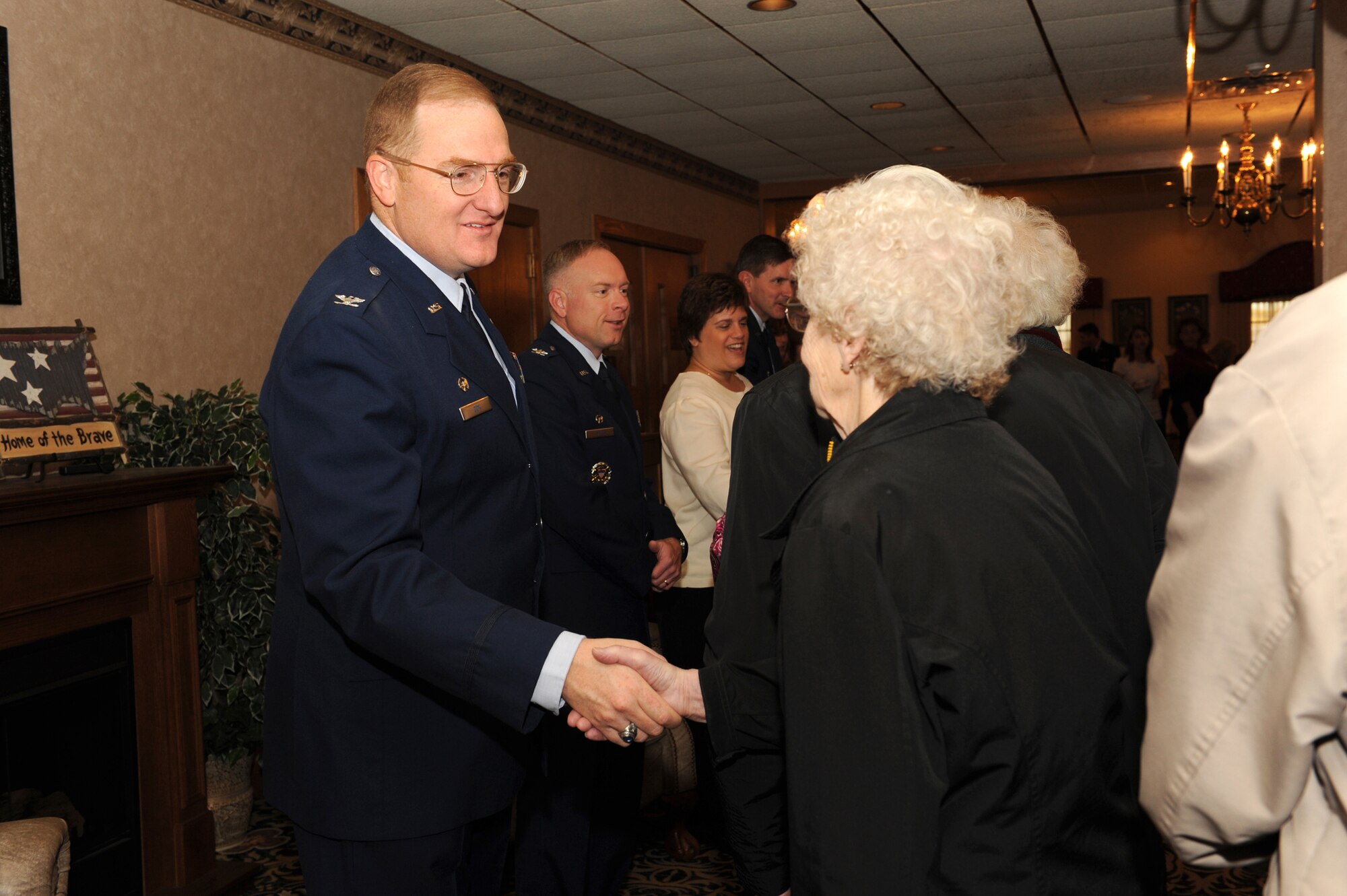 MINOT AIR FORCE BASE, N.D. -- Col. Douglas Cox, 5th Bomb Wing commander, greets senior citizens from Minot and the surrounding communities to a free Thanksgiving meal during the base’s annual “Day of Love” celebration here Nov. 26. The base has hosted the Day of Love since 1969, and its popularity with the base and local community has made it a long-standing tradition ever since. (U.S. Air Force photo by Airman 1st Class Jesse Lopez)