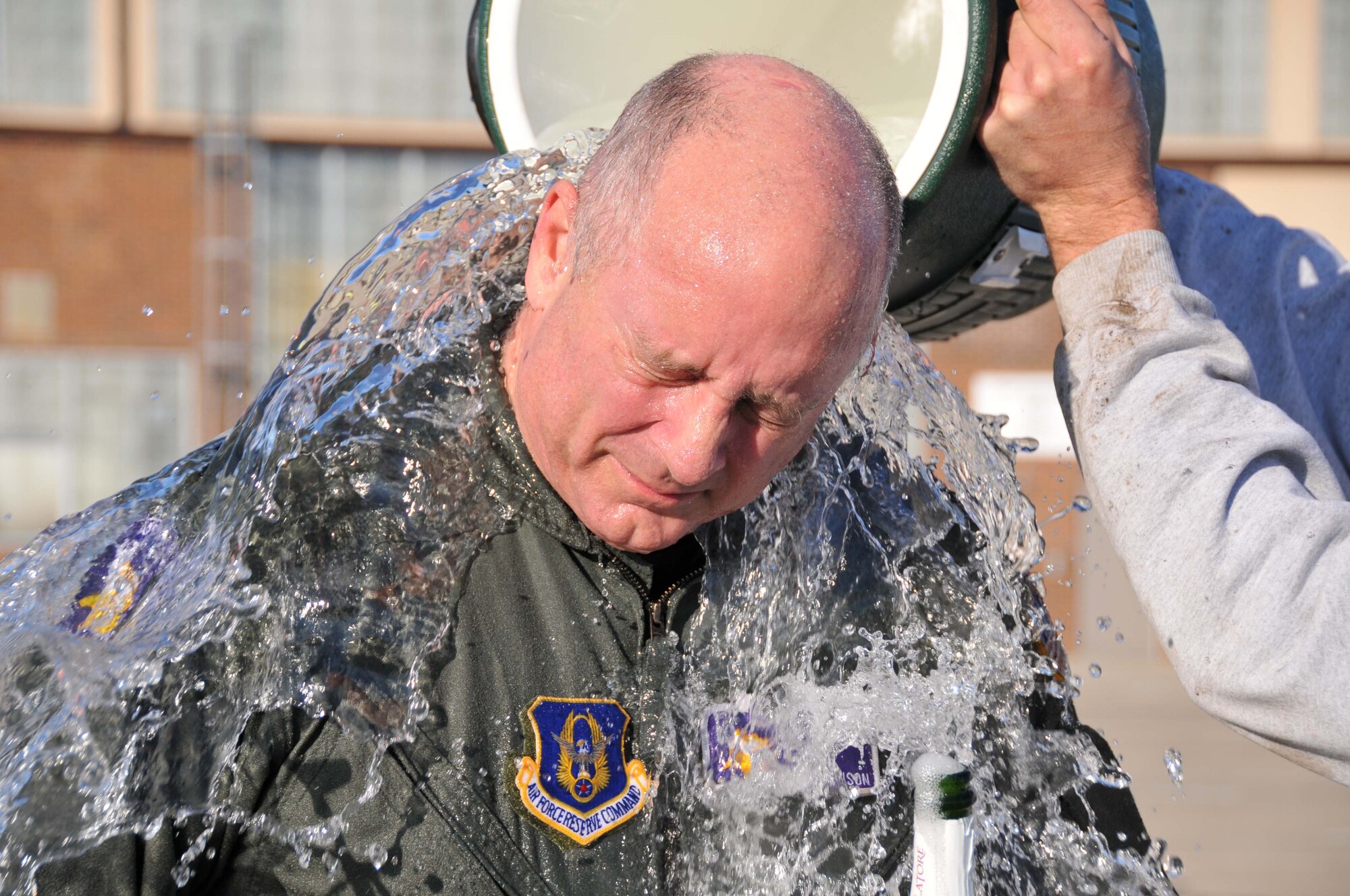Lt. Col. Mike Johnson, 96th Airlift Squadron, gets a ceremonial bath after his final C-130 flight Nov. 5. Colonel Johnson retired with more than 36 years service. (Air Force Photo/Master Sgt. Paul Zadach)