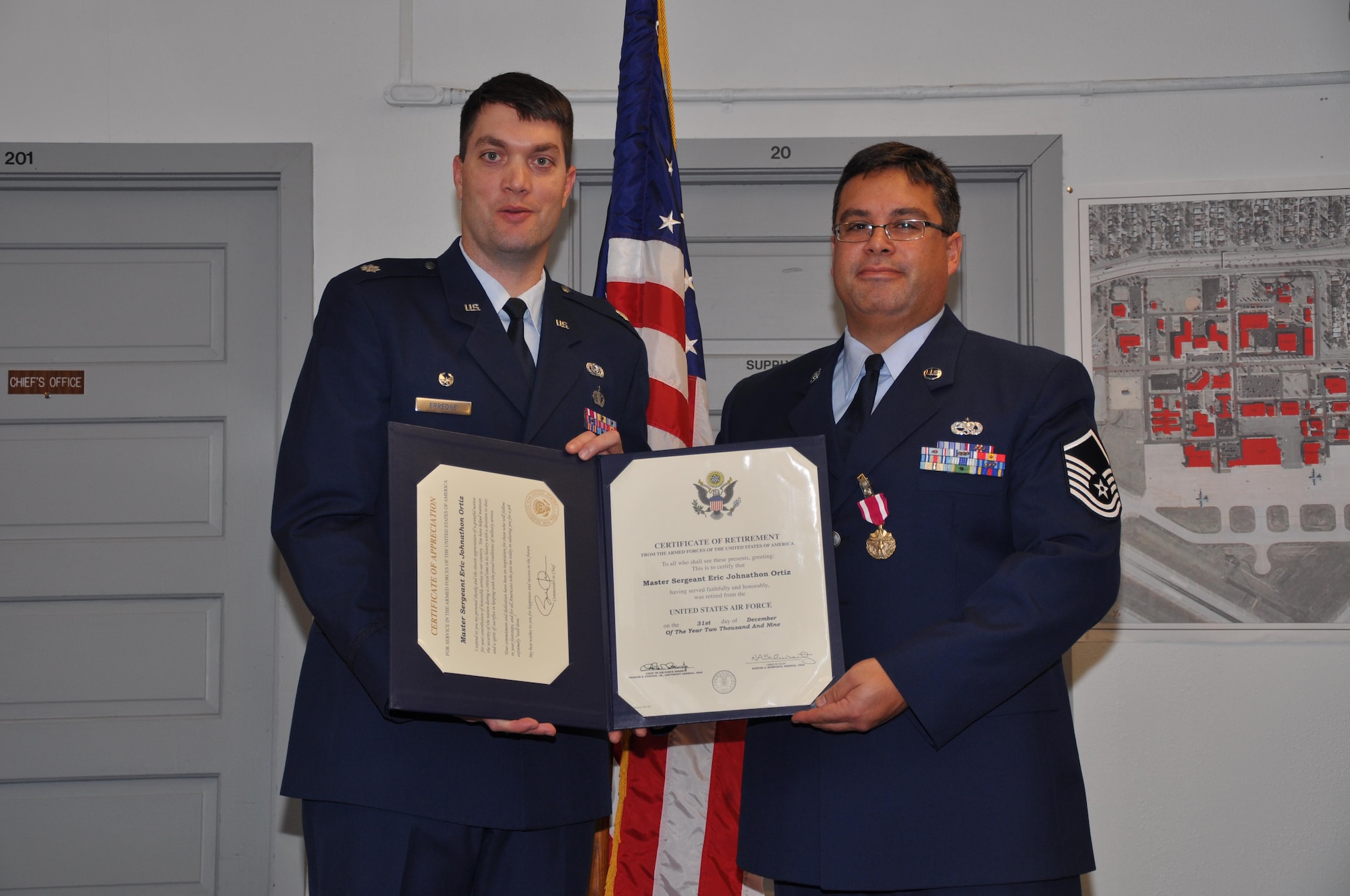 Master Sgt. Eric Ortiz recieves his retirement certificate from Lt. Col. Rick Erredge, 934th Communitcations Flight commander. (Air Force Photo/Tech. Sgt. Bob Sommer)