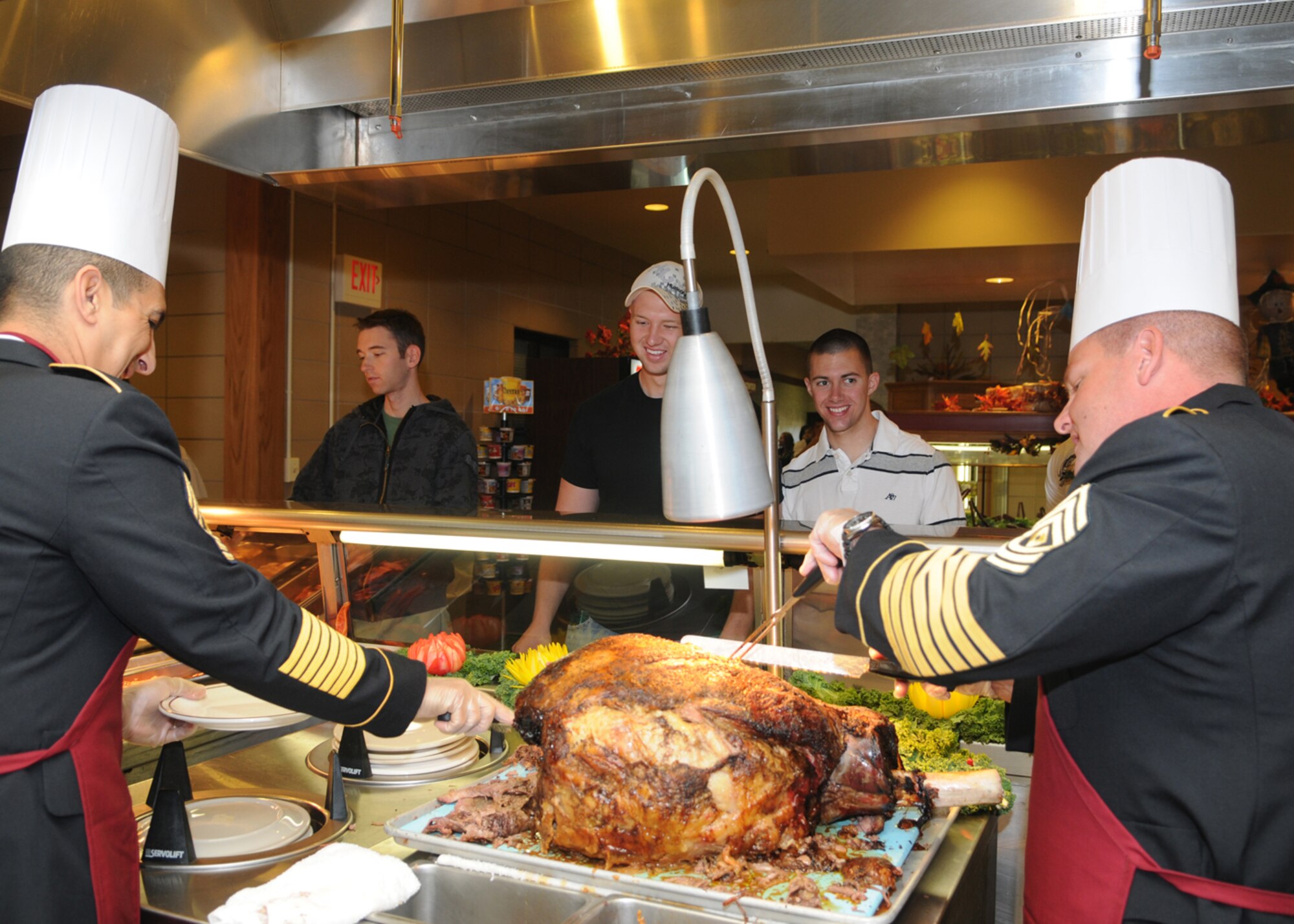 GOODFELLOW AIR FORCE BASE, Texas -- Army 1st Sgts. carve and serve a roast during a Thanksgiving meal at the Western Winds Dining Facility, Nov. 26, 2009. Each Thanksgiving leadership from the various units on base assists with serving the meal to dorm residents and others who remain on base during the holiday. (U.S. Air Force photo/Airman Clayton Lenhardt) 