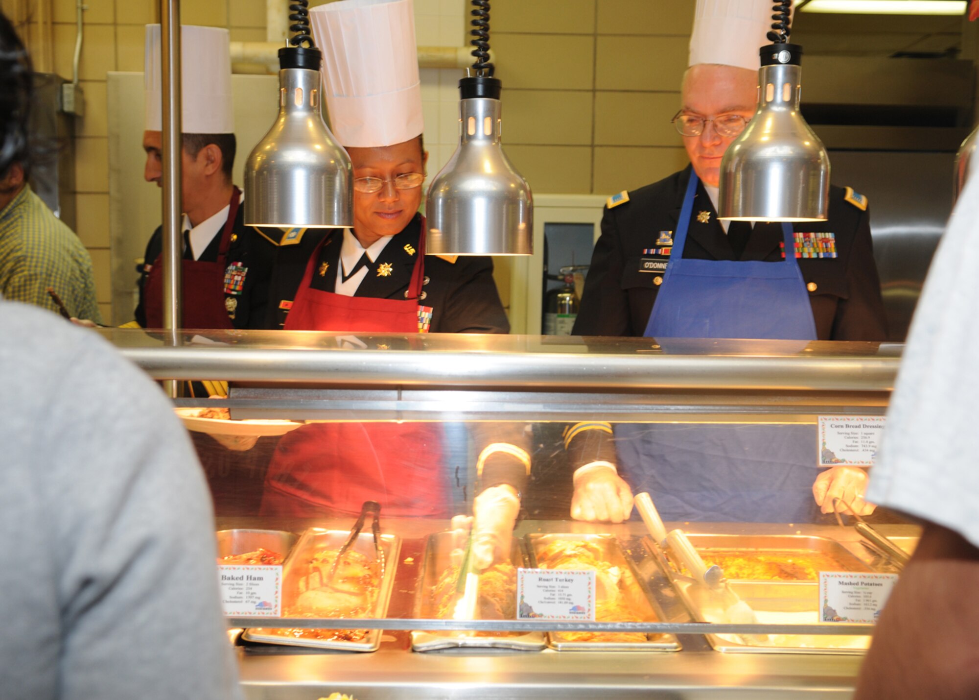 GOODFELLOW AIR FORCE BASE, Texas -- Army Lt. Col. Bichson Bush, 344th Military Intelligence Battalion commander, serves roast turkey during a Thanksgiving meal at the Western Winds Dining Facility, Nov. 26, 2009. Each Thanksgiving leadership from the various units on base assists with serving the meal to dorm residents and others who remain on base during the holiday. (U.S. Air Force photo/Airman Clayton Lenhardt)