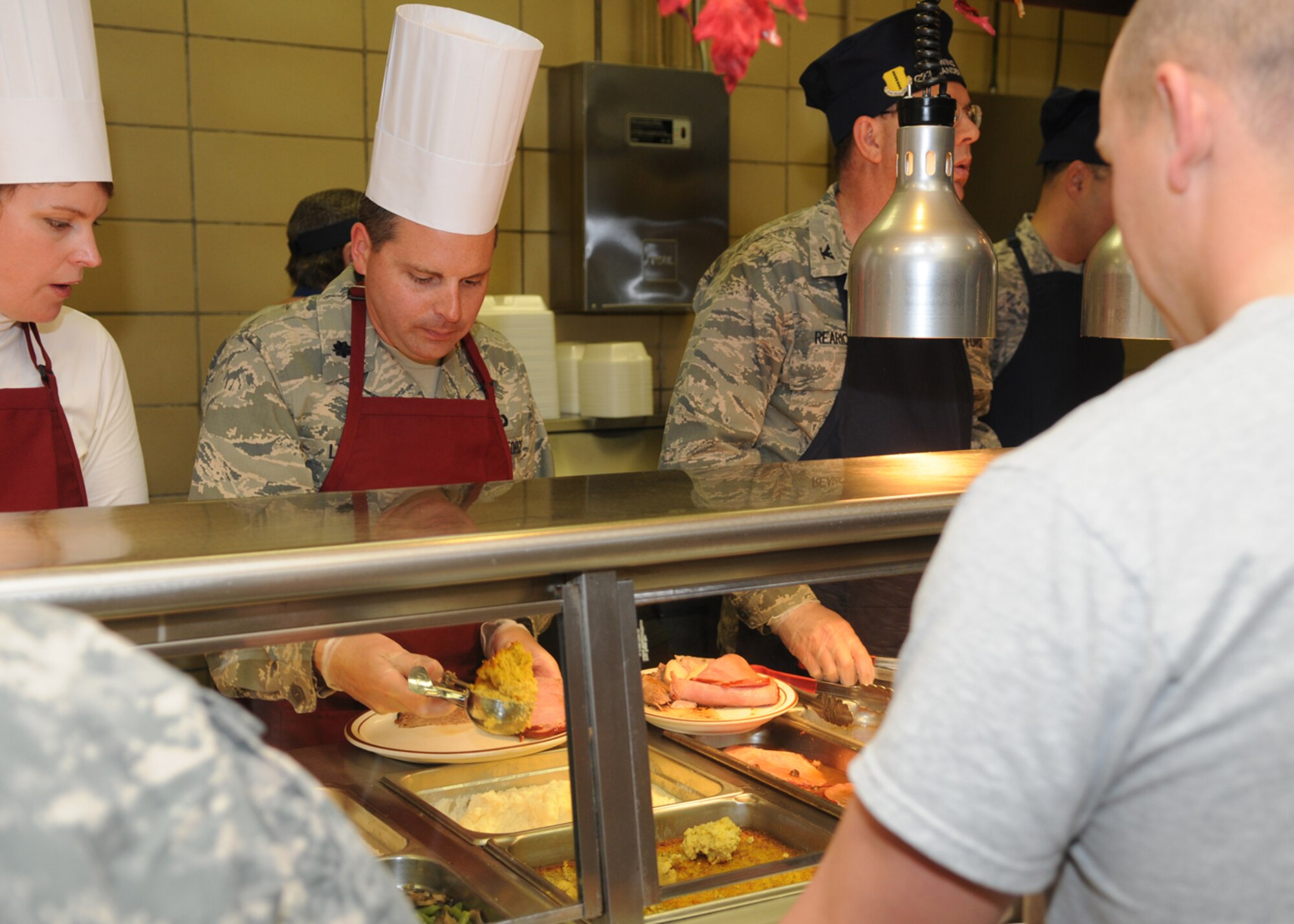 GOODFELLOW AIR FORCE BASE, Texas -- Lt. Col. Michael LePage, 17th Training Support Squadron commander, serves a scoop of stuffing at the Western Winds Dining Facility during a Thanksgiving meal, Nov. 26, 2009. Each Thanksgiving leadership from the various units on base assists with serving the meal to dorm residents and others who remain on base during the holiday. (U.S. Air Force photo/Airman Clayton Lenhardt)