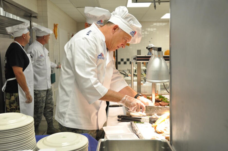 Gen. Gary North, Pacific Air Forces commander, carves turkey at the Hale Aina Dining Facility Nov. 26 at Hickam Air Force Base, Hawaii. Turkey, prime rib and all the trimmings were available to Hickam Airmen, dependents, visiting family members and retirees for Thanksgiving. General North was joined by senior leadership from 13th Air Force, the 15th Airlift Wing and several members of the Air Force Civilian Advisory Council. The facility prepared food in anticipation of nearly 400 guests. (Department of Defense photo/Tech. Sgt. Cohen A. Young)