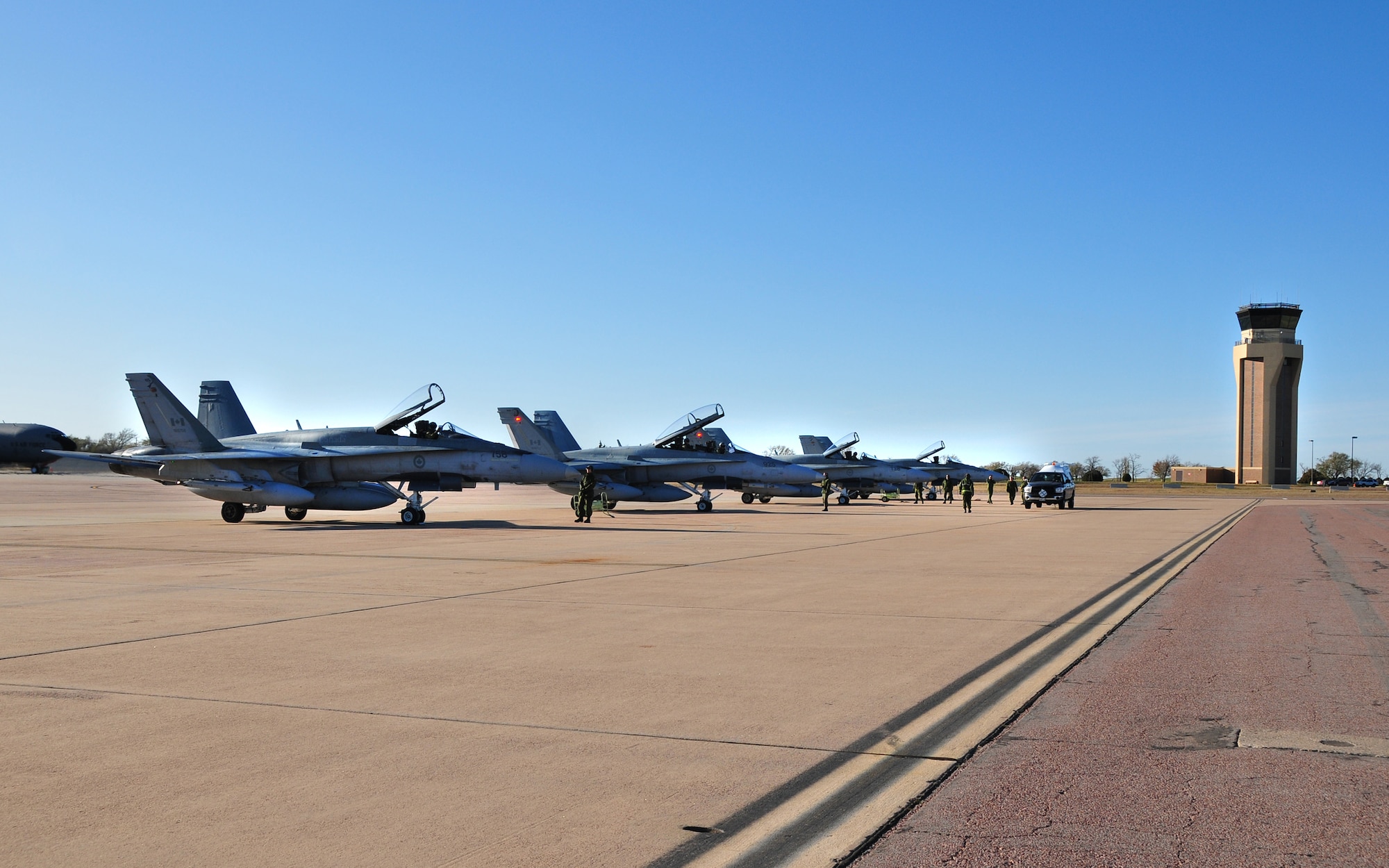 ALTUS AIR FORCE BASE, Olka. -- As the CF-18 Hornets line up on their
designated spot on the parking ramp, the pilots prepare to exit their
aircraft. The 425th Tactical Fighter Squadron are temporarily deployed to
Altus from Canadian Forces Base Bagotville in Quebec, Canada. (U.S Air Force Photo/Senior Airman Amanda Bower)

