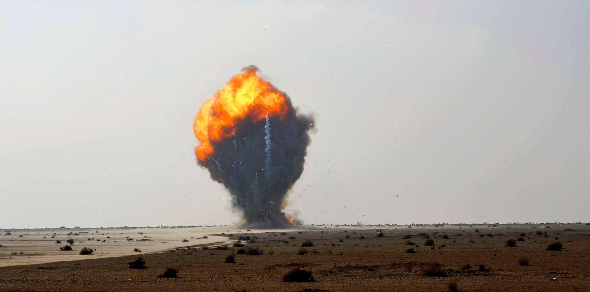 Over 1,000 pounds of explosive ordnance explodes in a controlled detonation performed by Iraqi and U.S. Air Force explosive ordnance disposal technicians Nov. 23, 2009, at Mahmudiyah, Iraq. The Airmen are assigned to the 447th Expeditionary Civil Engineer Squadron. (U.S. Air Force photo/Staff Sgt. Angelita Lawrence)