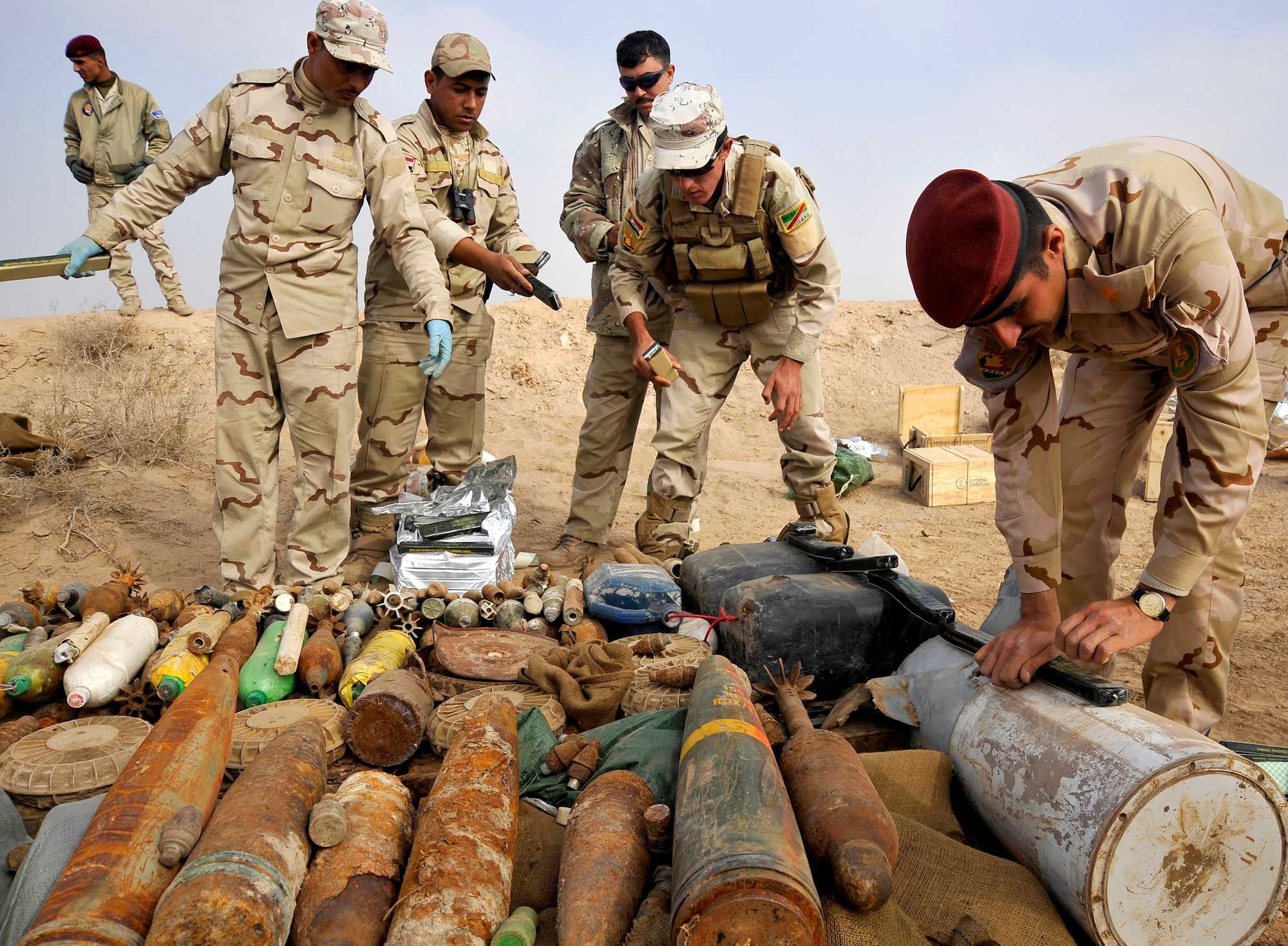 Iraqi army soldiers place C-4 explosives on a collection of loose ordnance in preparation for a control detonation, Nov. 23, 2009 at Mahmudiyah, Iraq. The purpose of the control detonation is to mitigate explosives hazards and limit the enemy's war-fighting capabilities in Iraq.  (U.S. Air Force photo/Staff Sgt. Angelita Lawrence)