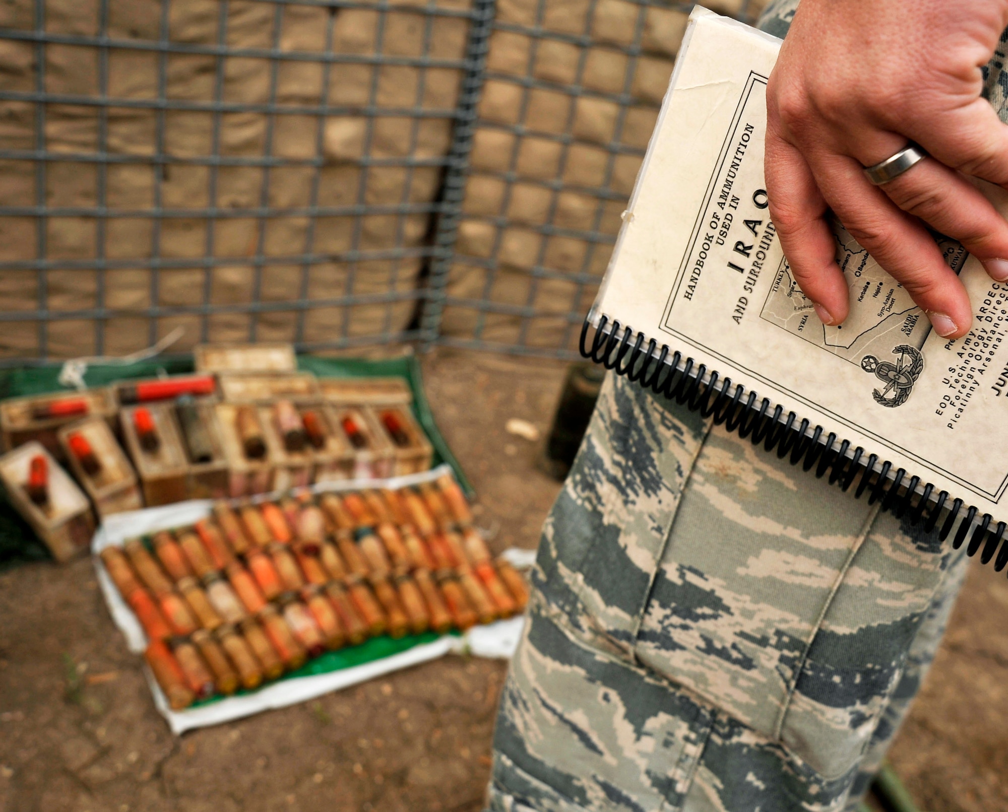 Staff Sgt. Cody Flood collects data on the number of explosives to prepare for a controlled detonation, Nov. 23, 2009, at Mahmudiyah, Iraq. Sergeant Flood is a 447th Expeditionary Civil Engineer Squadron explosive ordnance disposal technician. (U.S. Air Force photo/Staff Sgt. Angelita Lawrence)
