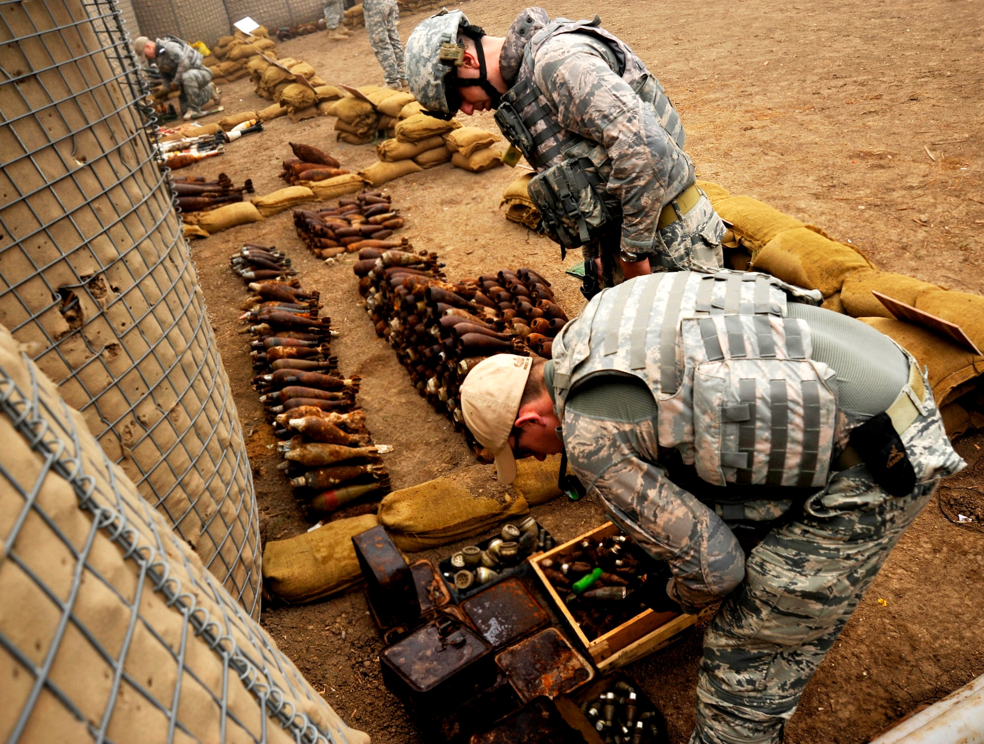 Staff Sgts. Cody Flood and Michael Jamison collect data on explosives in preparation for a controlled denotation Nov. 23, 2009, at Mahmudiyah, Iraq. Sergeants Flood and Jamison are 447th Expeditionary Civil Engineer Squadron explosive ordnance disposal technicians. (U.S. Air Force photo/Staff Sgt. Angelita Lawrence)
