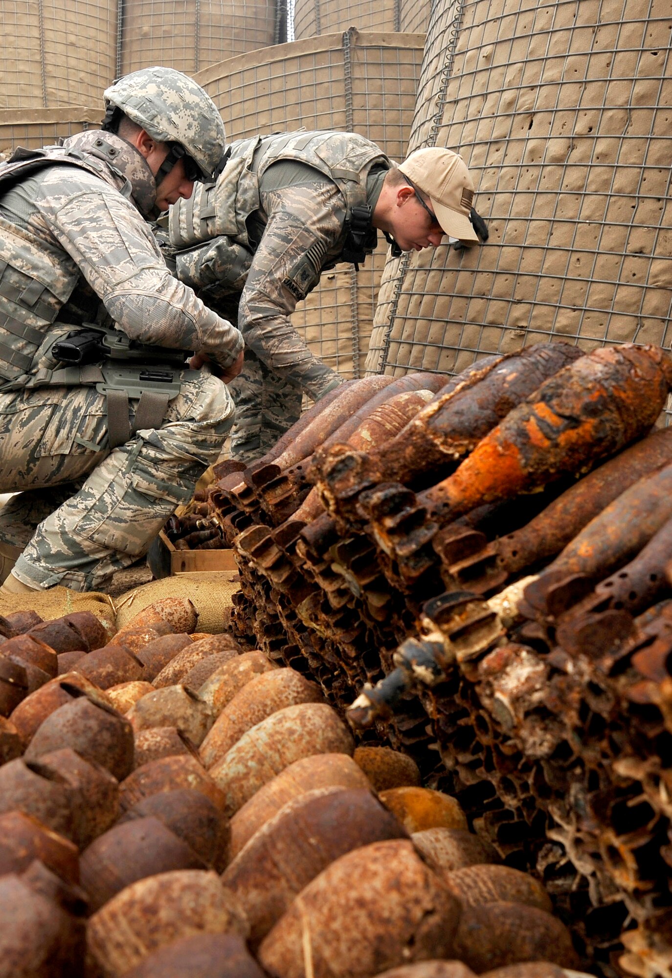 Staff Sgts. Cody Flood and Michael Jamison collect data on explosives in preparation for a controlled detonation Nov. 23, 2009, at Mahmudiyah, Iraq. Sergeants Flood and Jamison are 447th Expeditionary Civil Engineer Squadron explosive ordnance disposal technicians. (U.S. Air Force photo/Staff Sgt. Angelita Lawrence) 